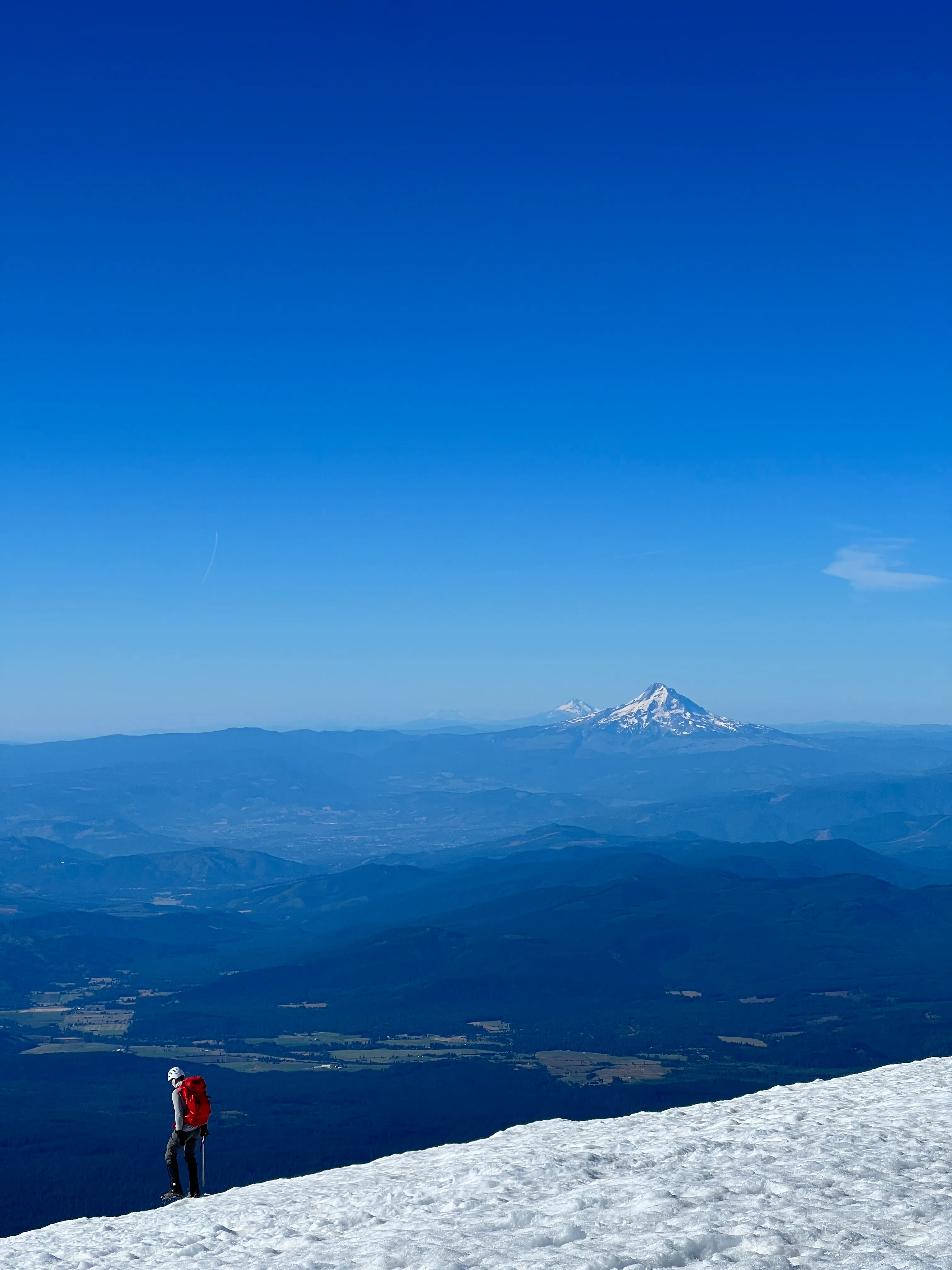 The Oregon Cascades lined up from 12,000 ft: Hood, Jefferson, and the Sisters