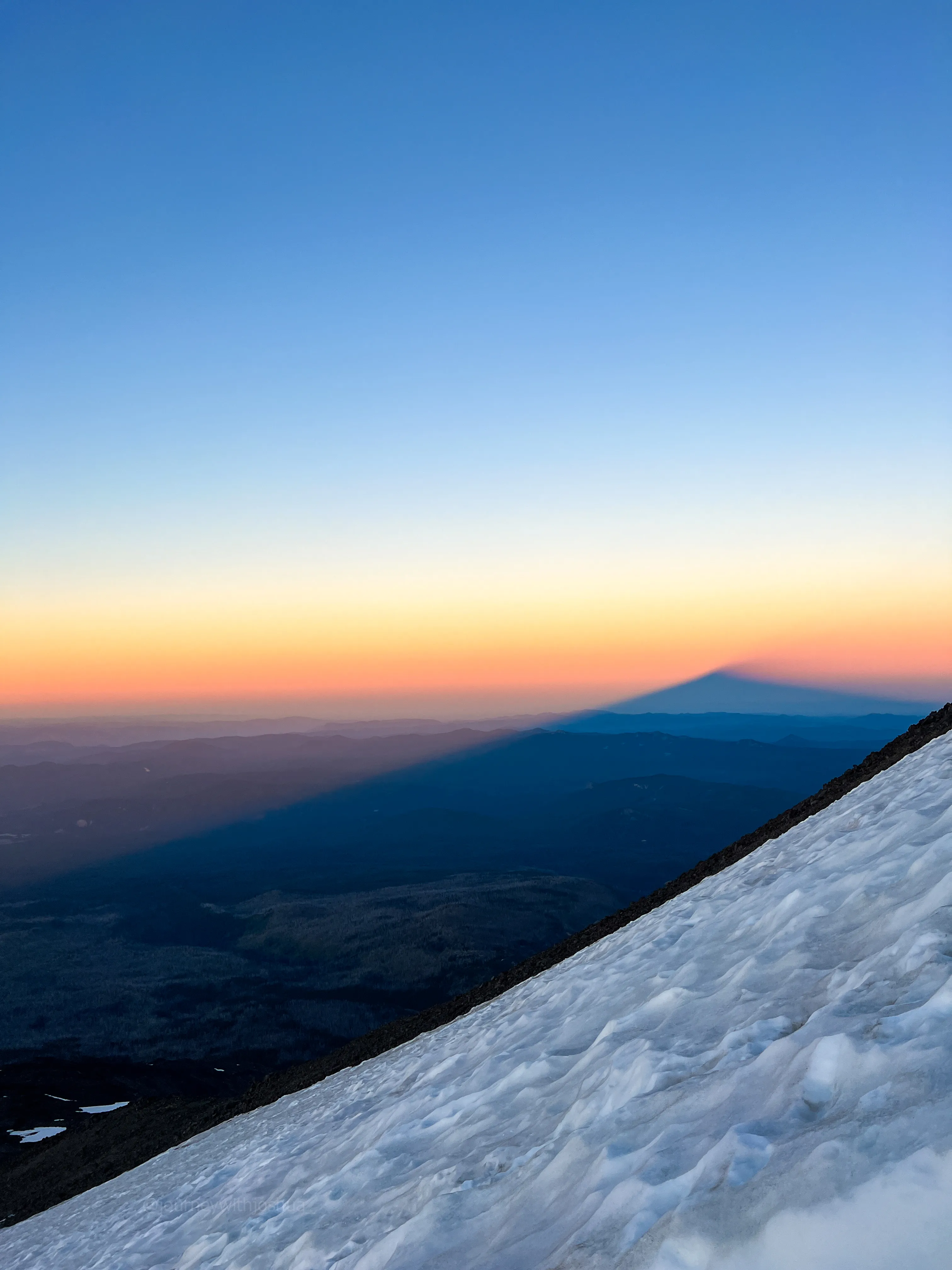 Mount Adams casting its shadow across the horizon at first light