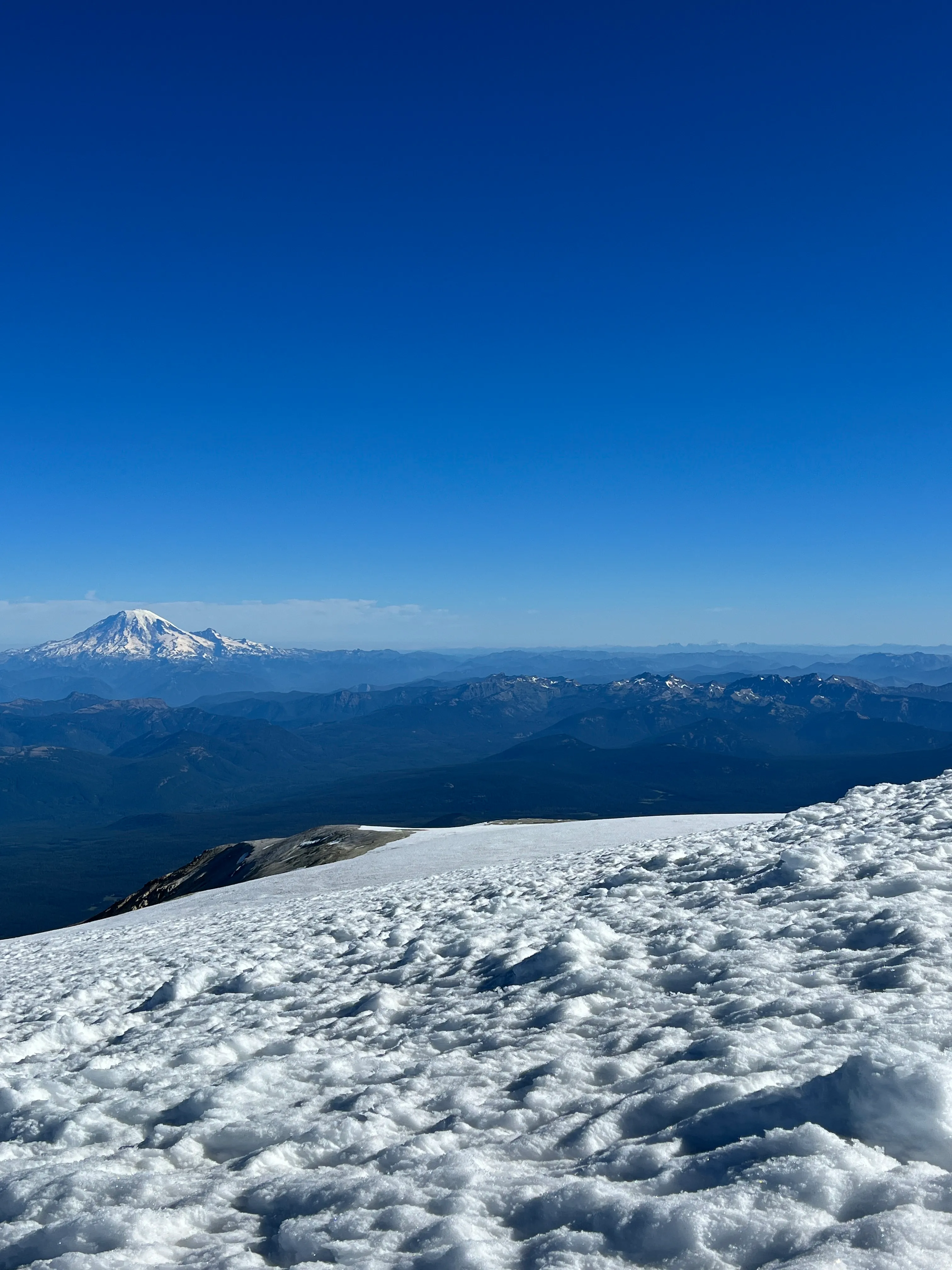 The big flat summit of Mount Adams with Mount Rainier in the distance