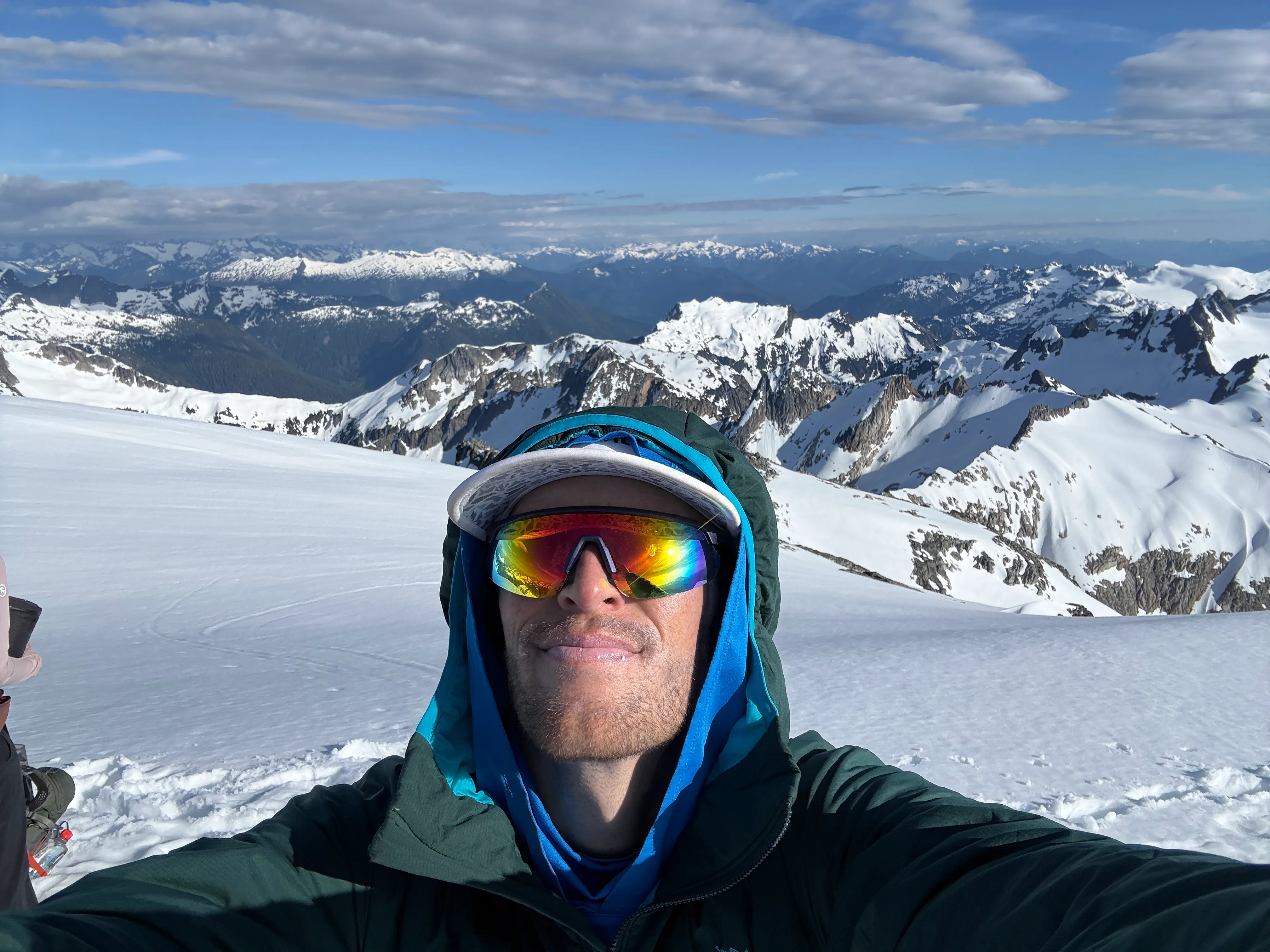 Bundled against the wind, arriving at the summit
