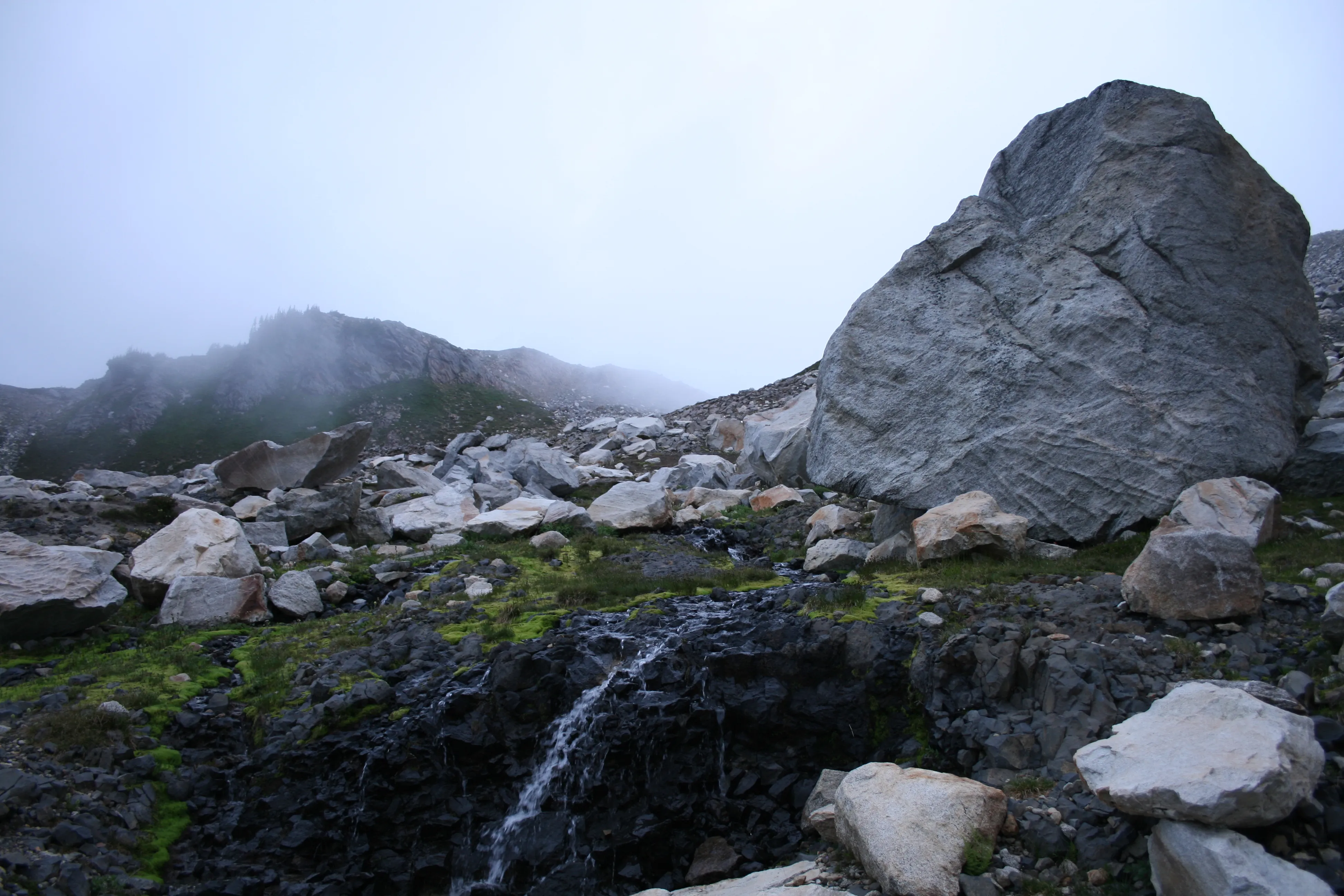 An otherworldly basin of rock and fog, are we still on Earth