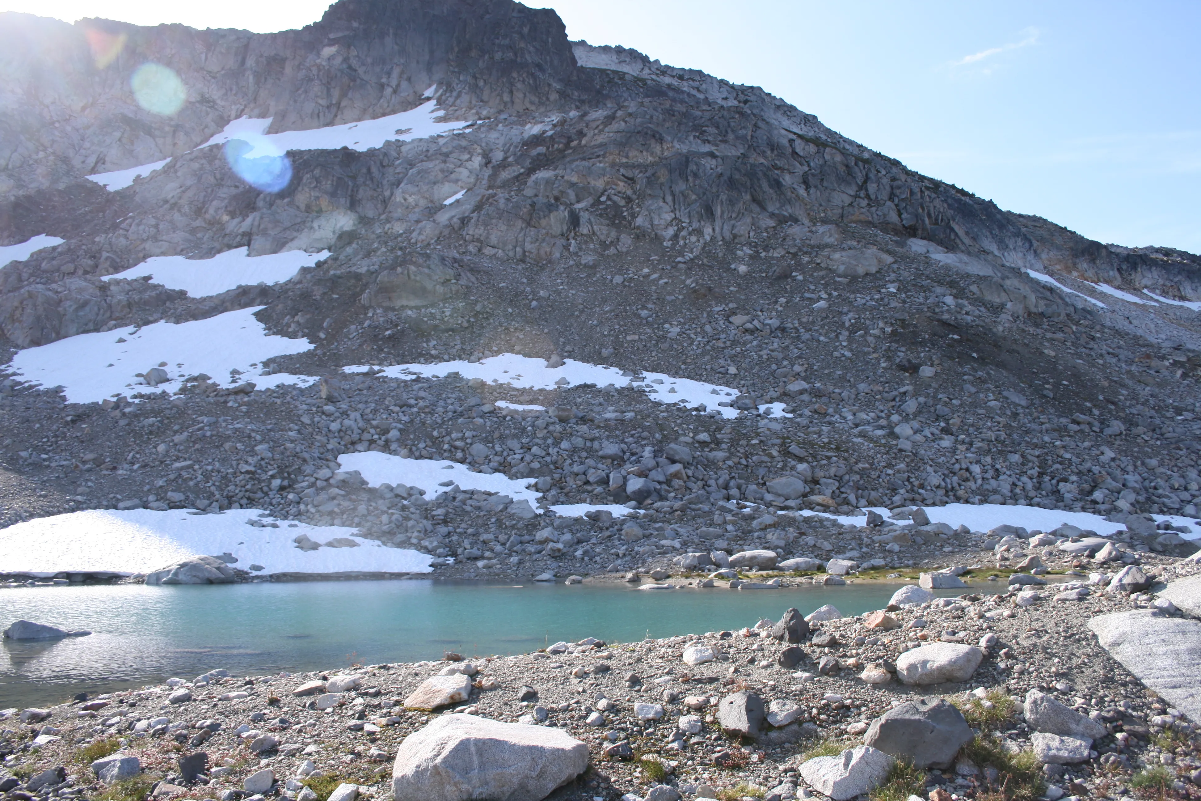 A glacial blue tarn scattered in the rocky basin