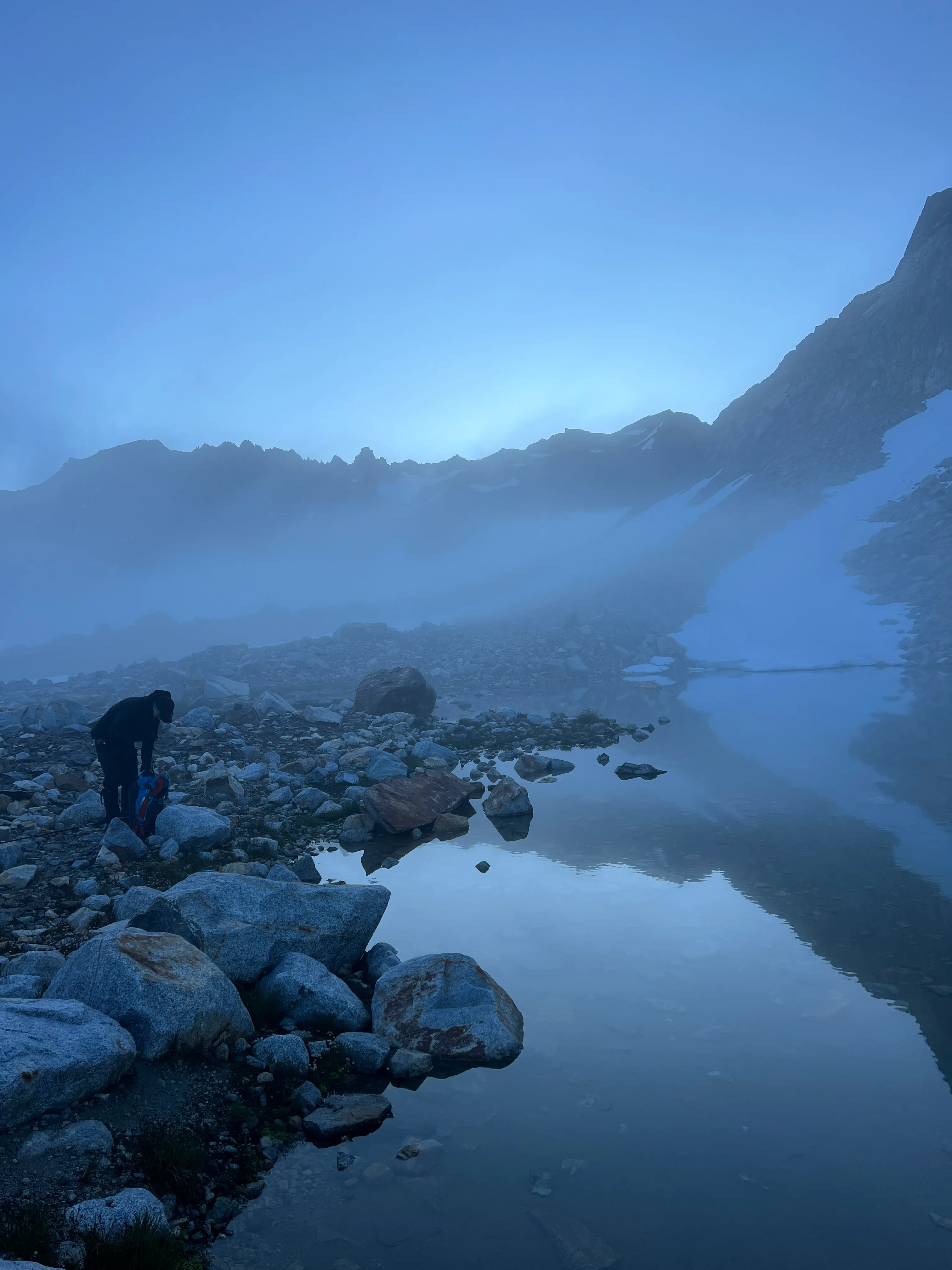 Jack filling up his water at the tarn to start summit day