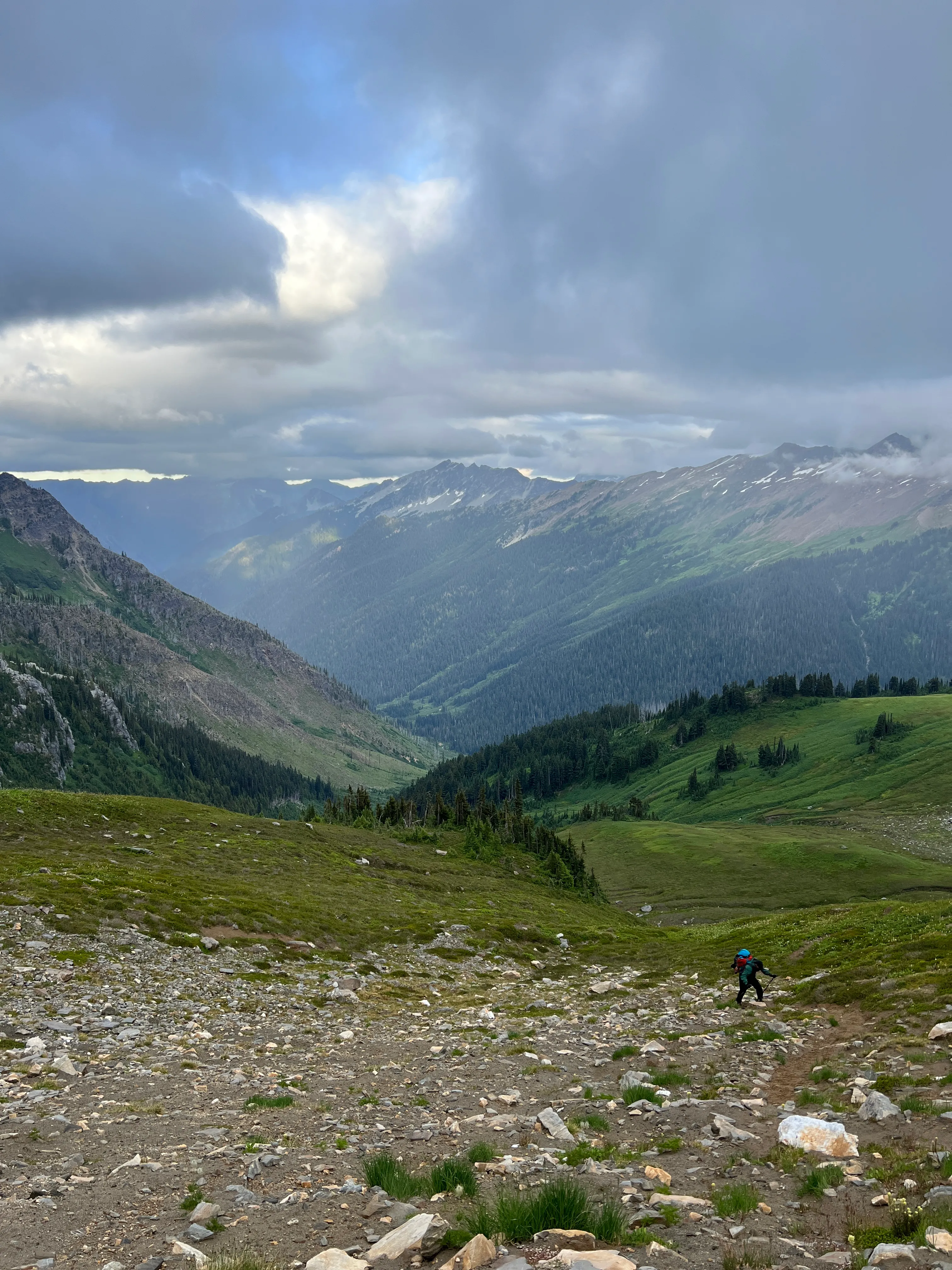 Jack hiking up toward White Pass with ominous clouds moving over us