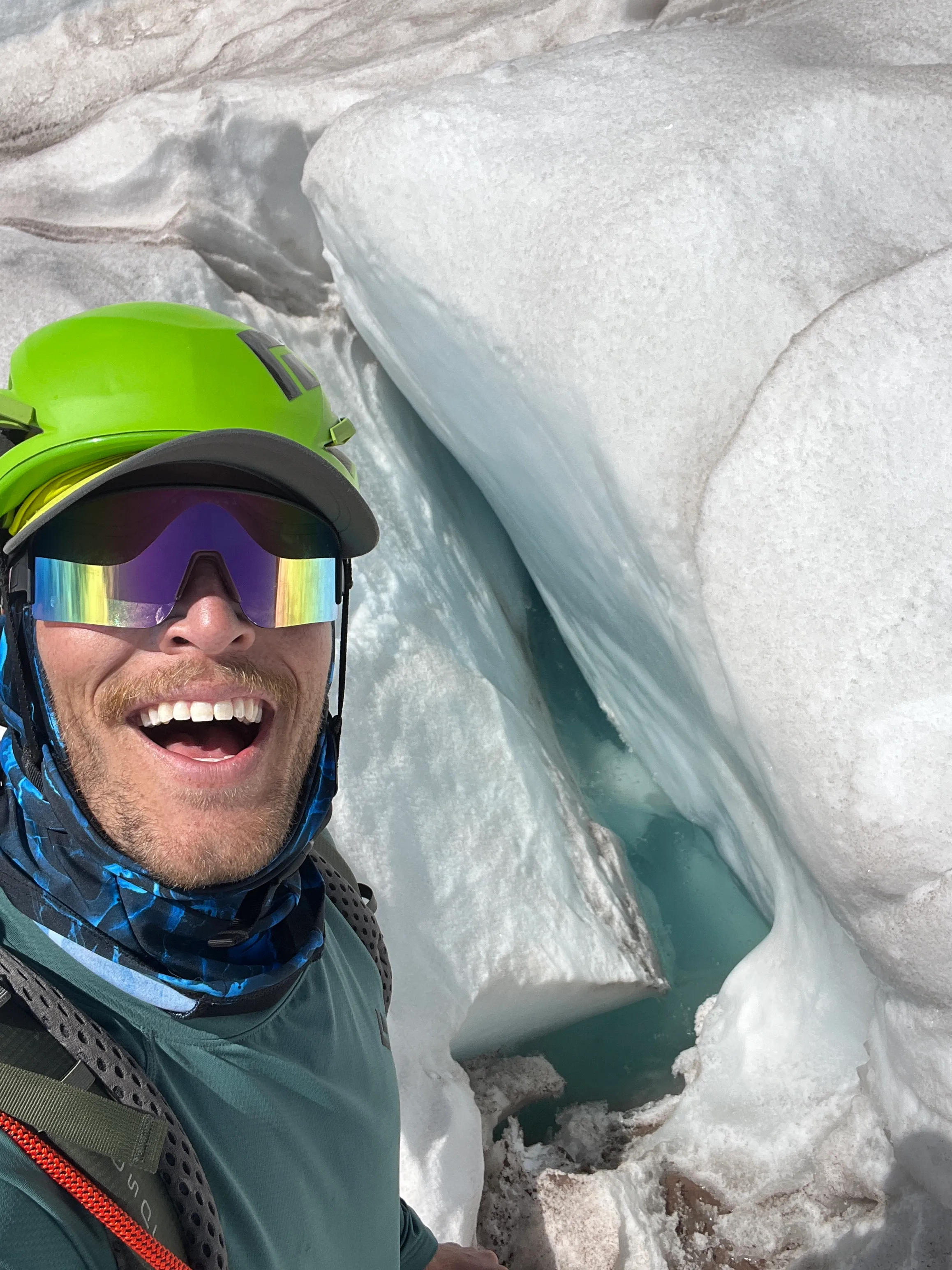 Selfie standing above a deep crevasse with heavy water flow on the icefall