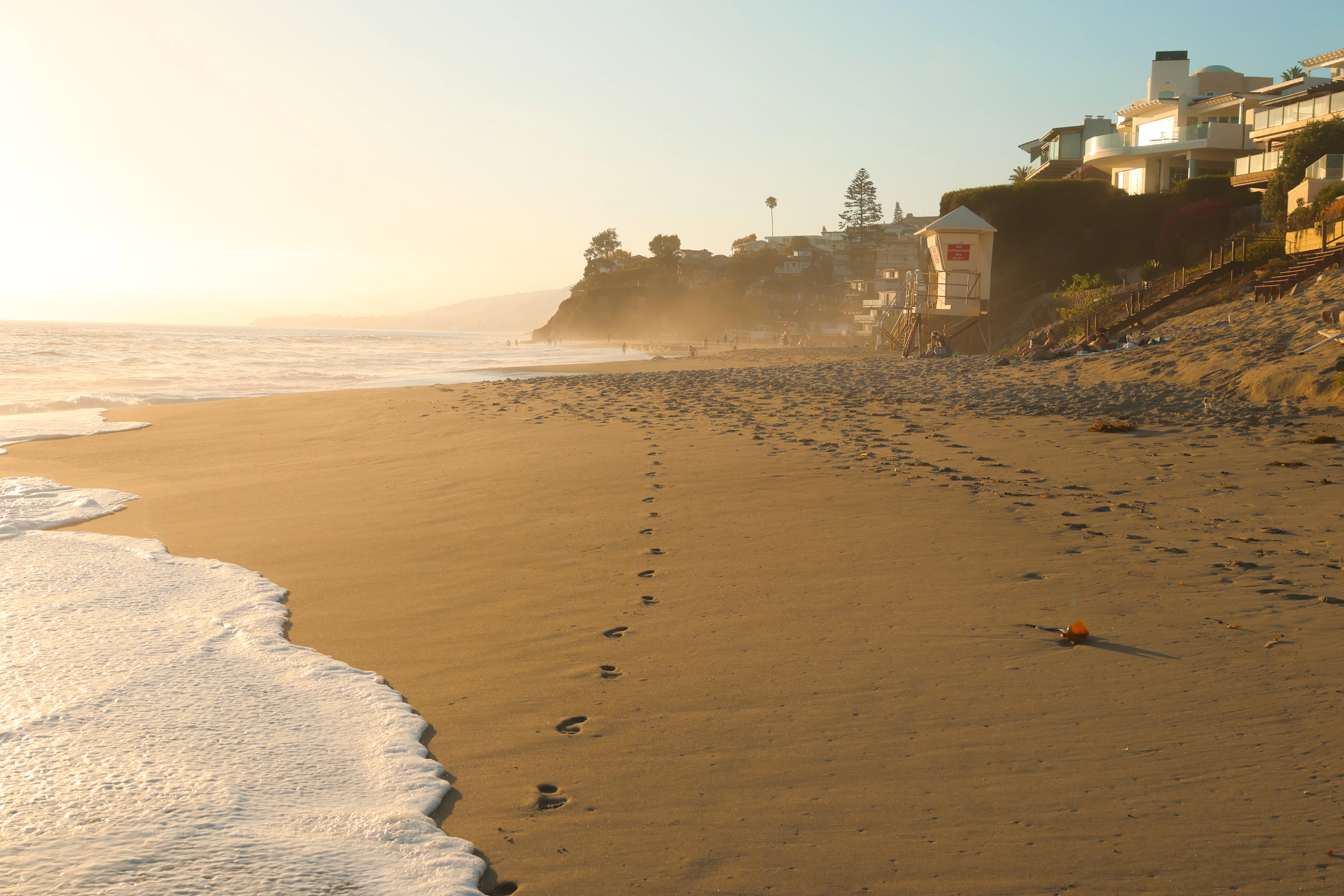 Footprints in the sand at the end of the day on Laguna Beach.