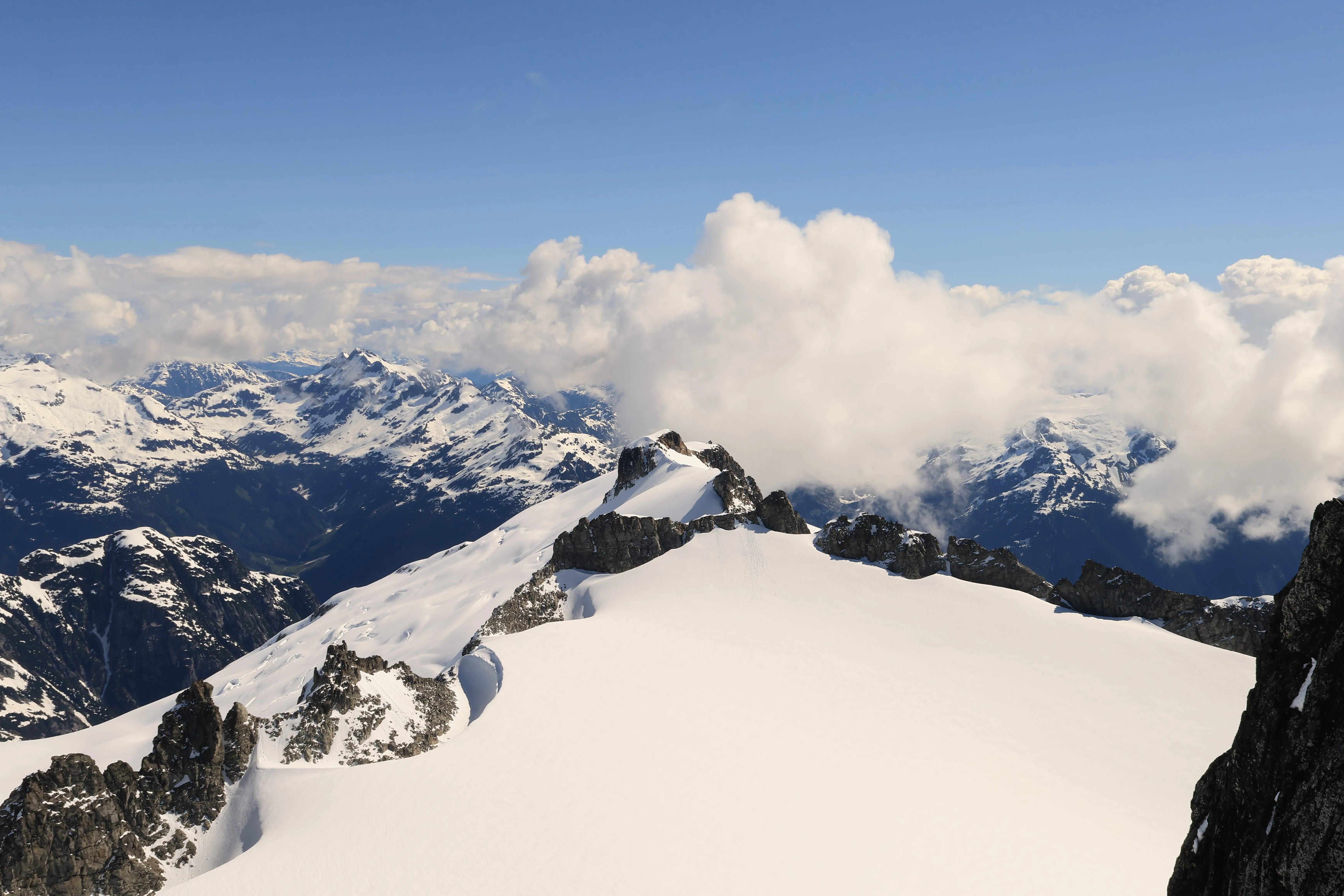 Clouds over the Canadian peaks from the summit saddle
