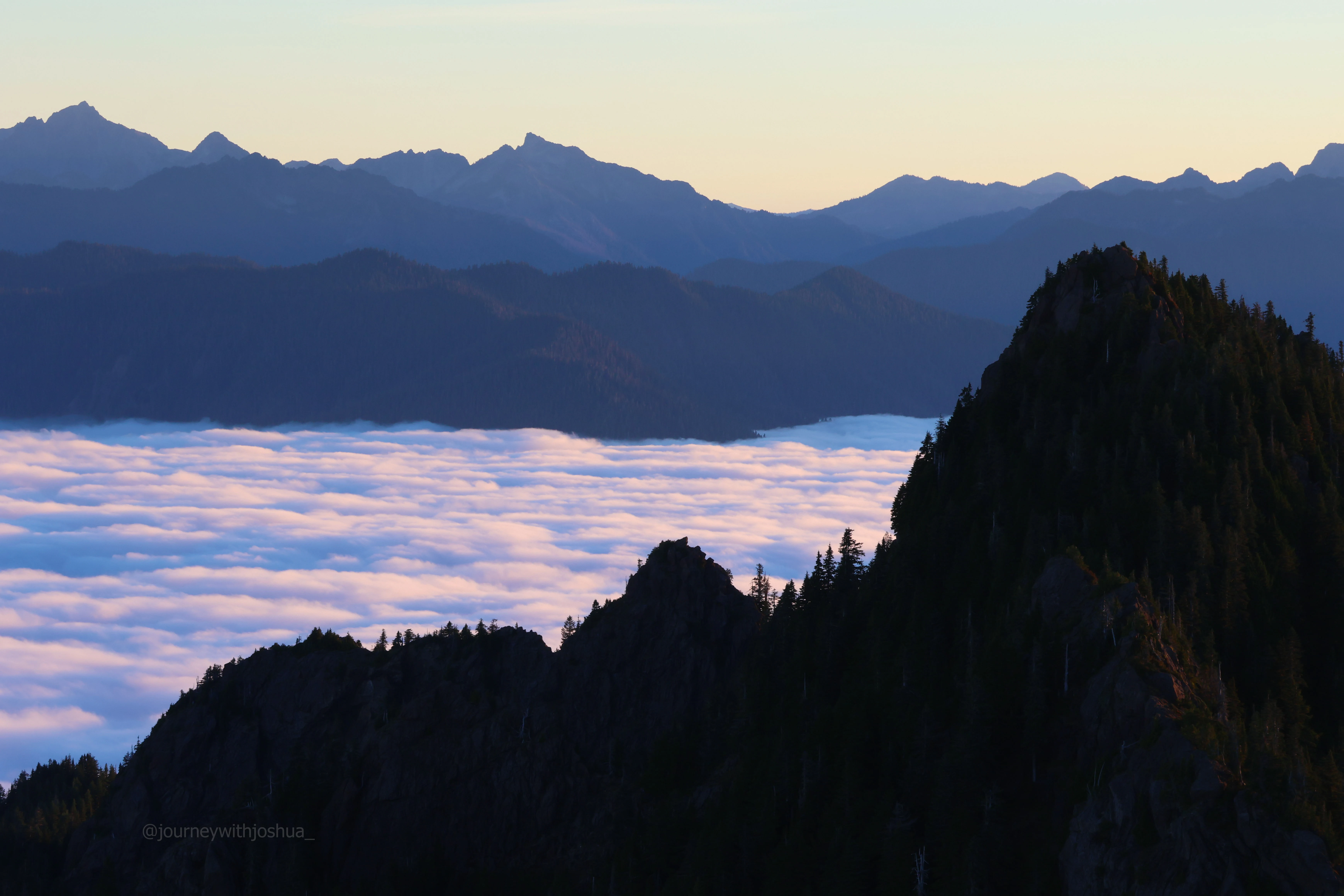 The light dancing on the clouds at sunrise over the Olympic Range.