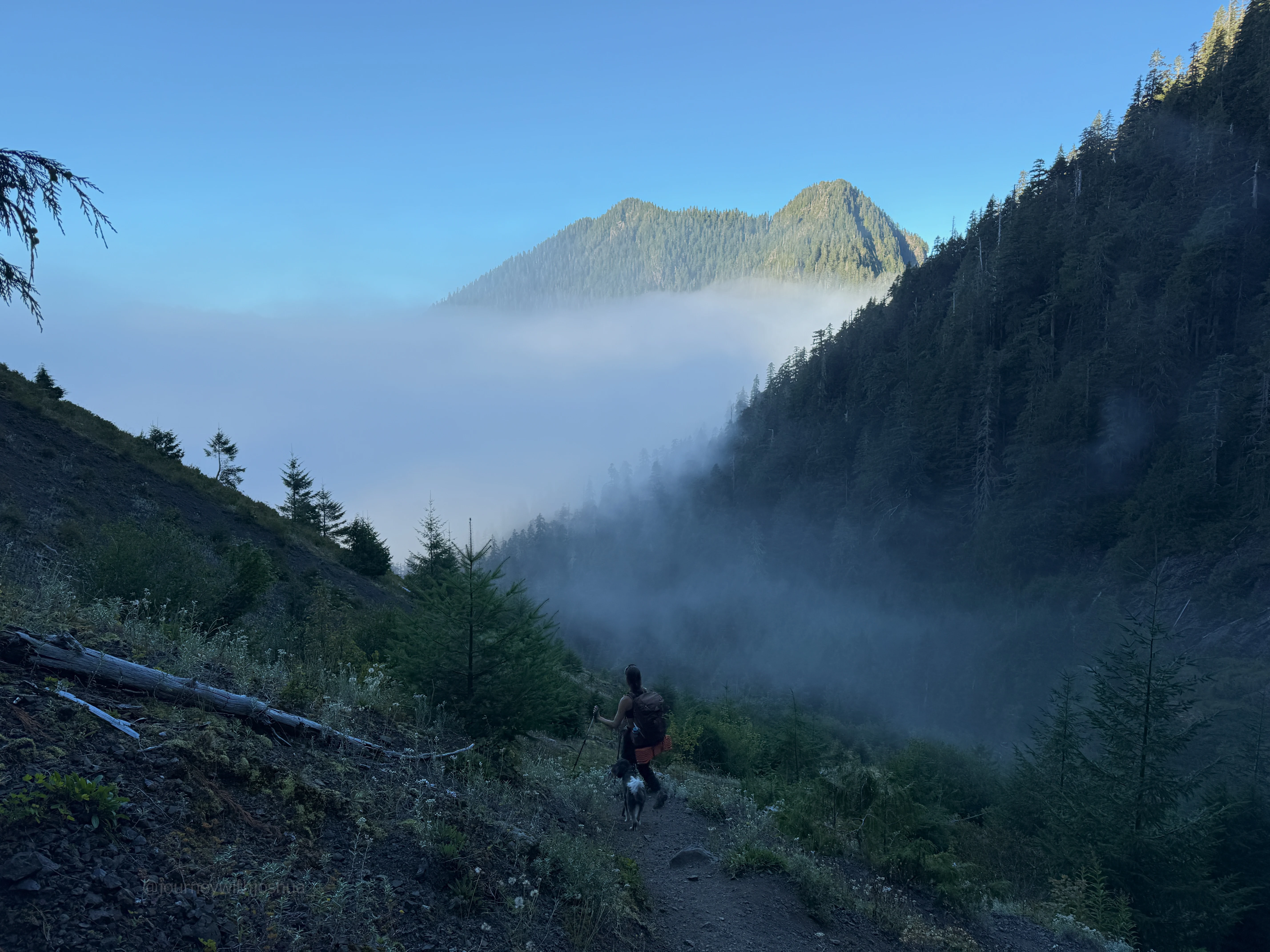 Haley and Izzy cruising down the trail into the clouds for the Olympic Range exit.