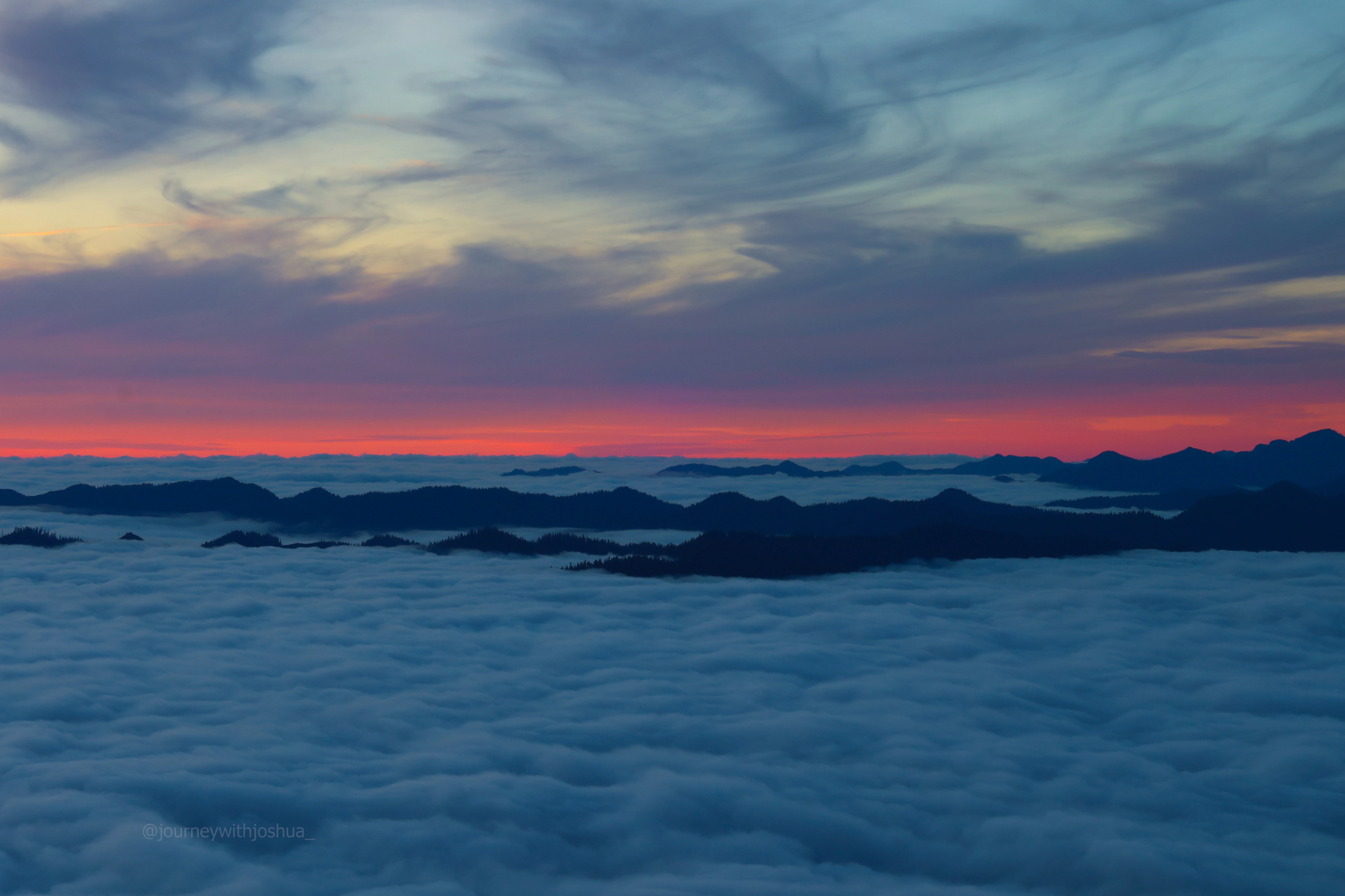 Burner cloud layers during sunset over the Olympic Range.