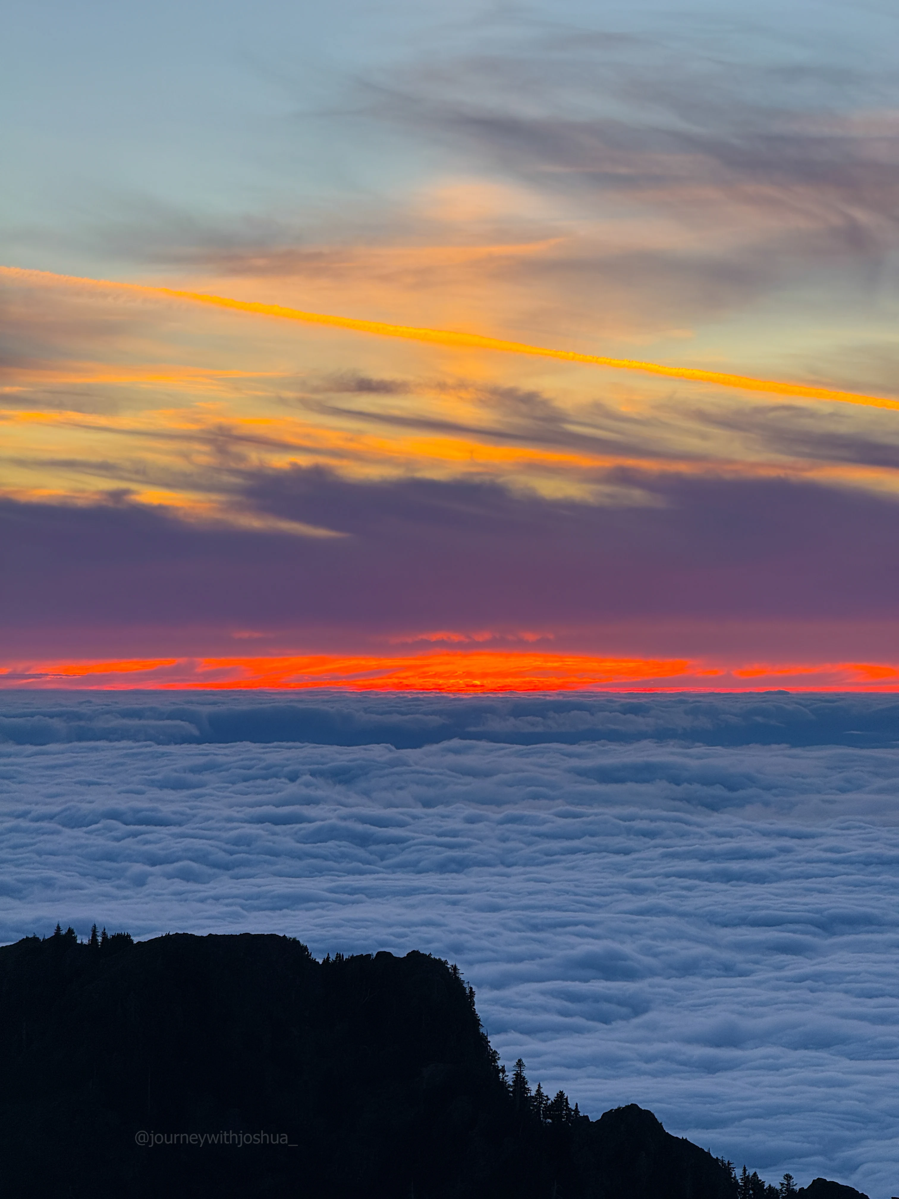An interesting vertical light pillar in the sky during the burner sunset over the Olympic Range.