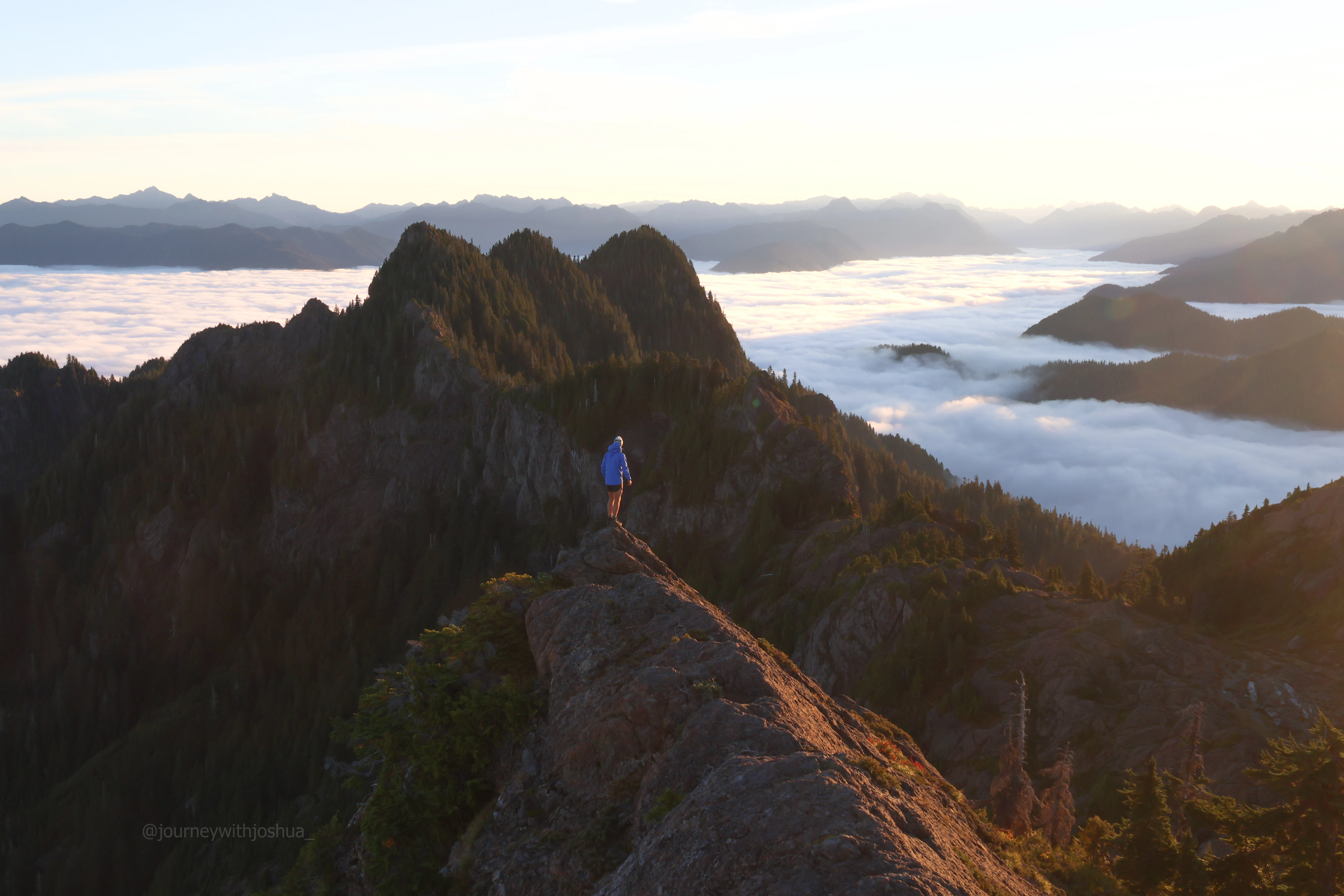 Joshua rocking the usual shorts and gorpcore combo at sunrise in the Olympic Range. Photo by Haley.