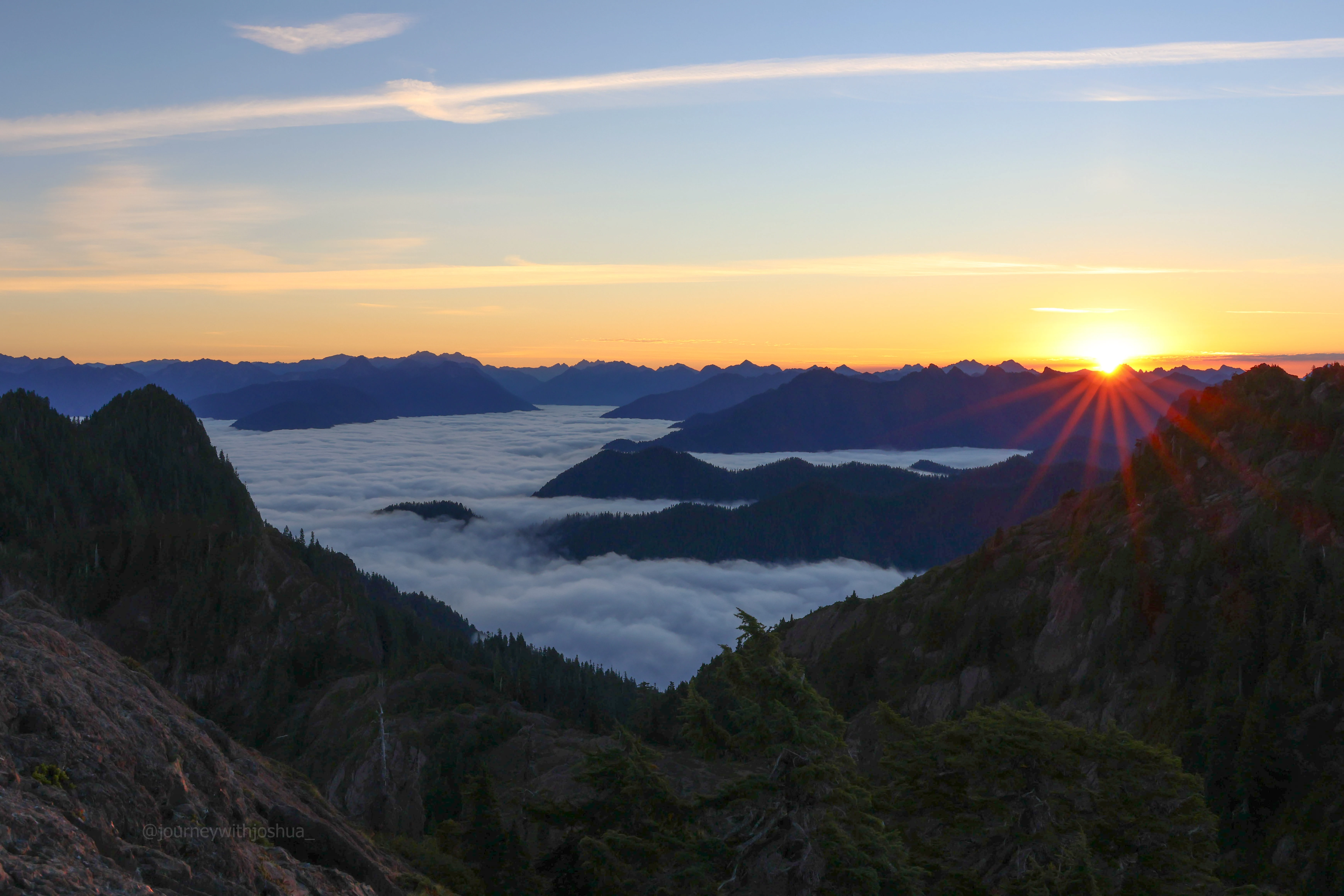 The cloud inversion still persistent at sunrise over the Olympic Range.