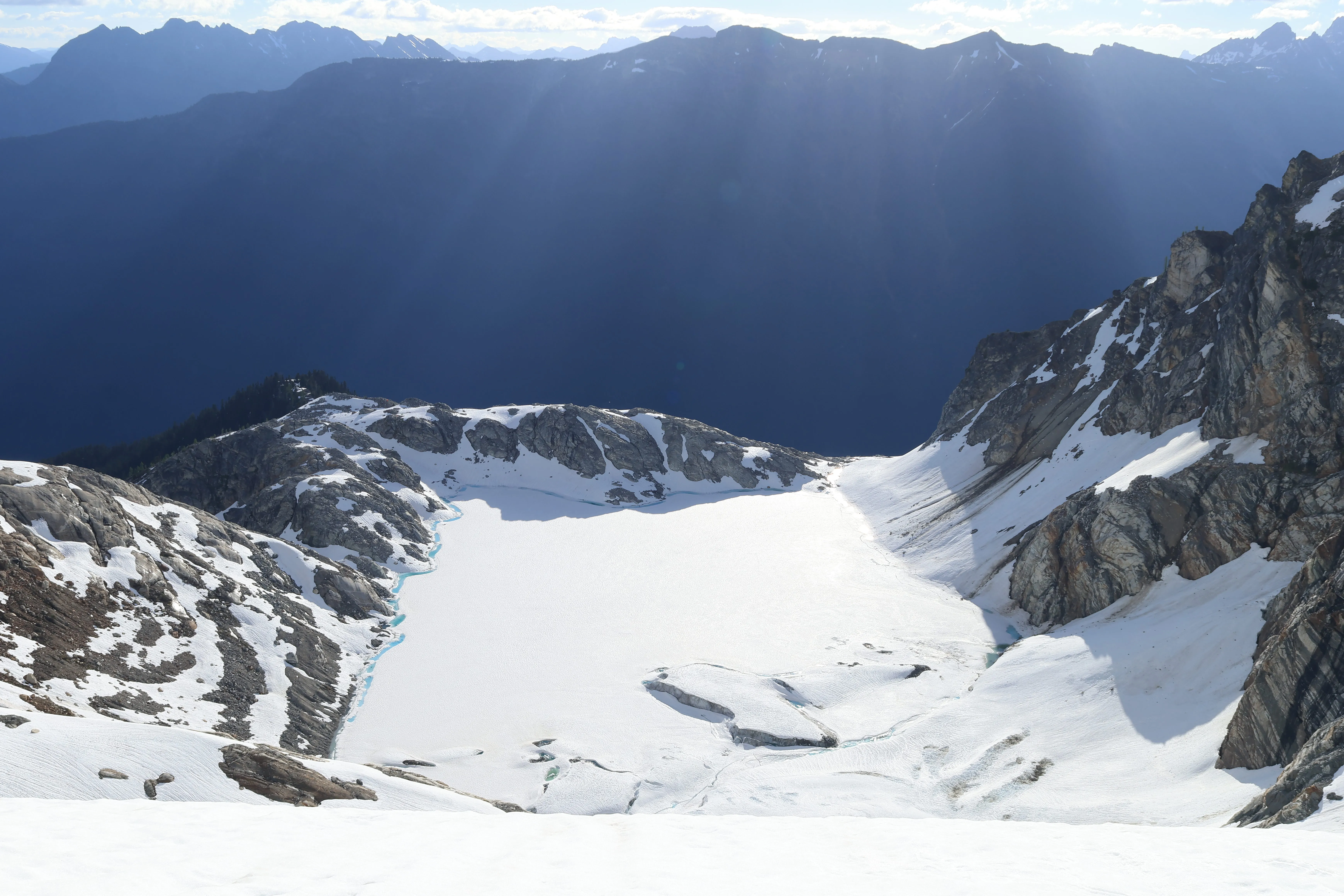 Light rays breaking over Borealis Lake seen from the Borealis Glacier