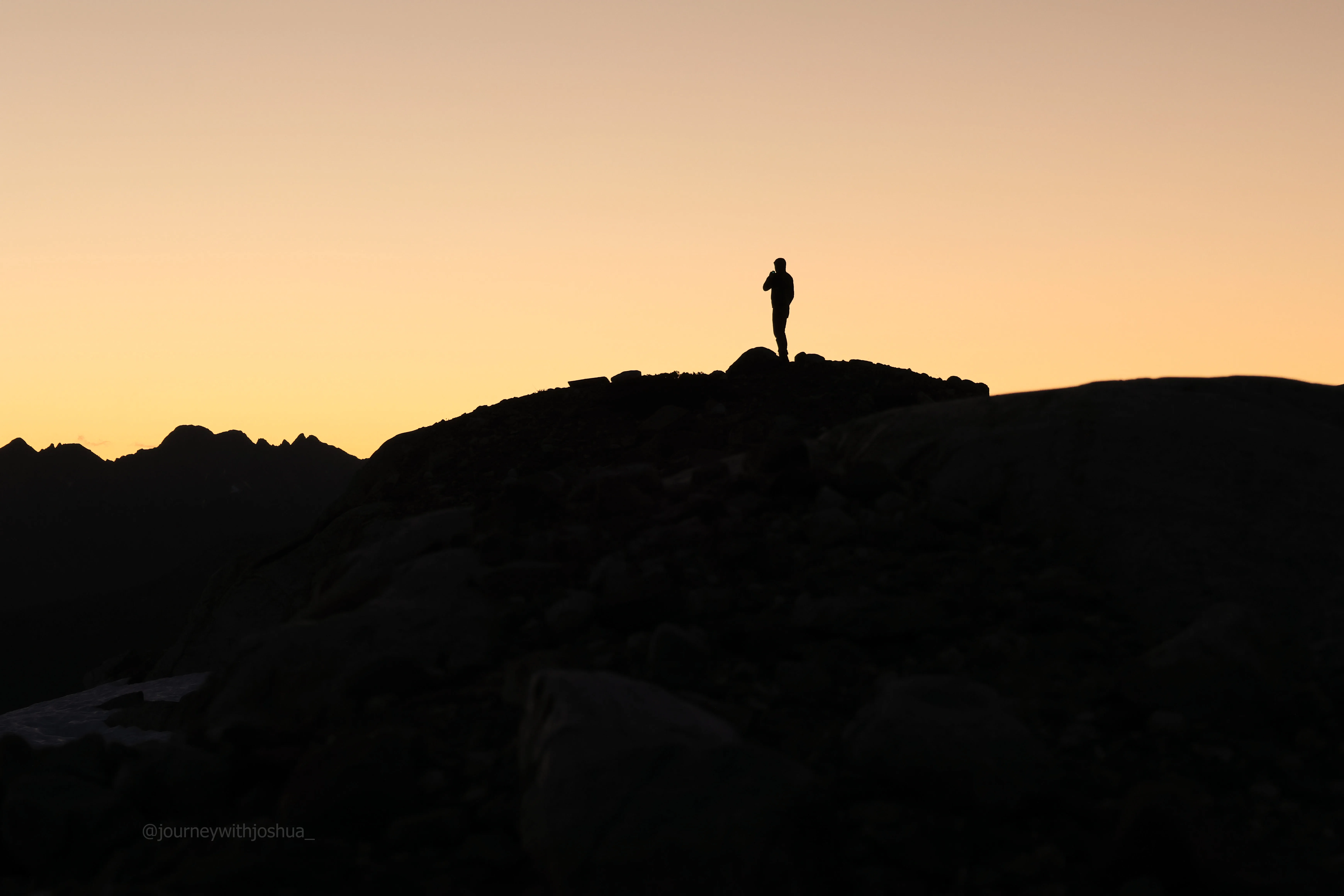 Dan making sunrise coffee at high camp near Mount Primus.