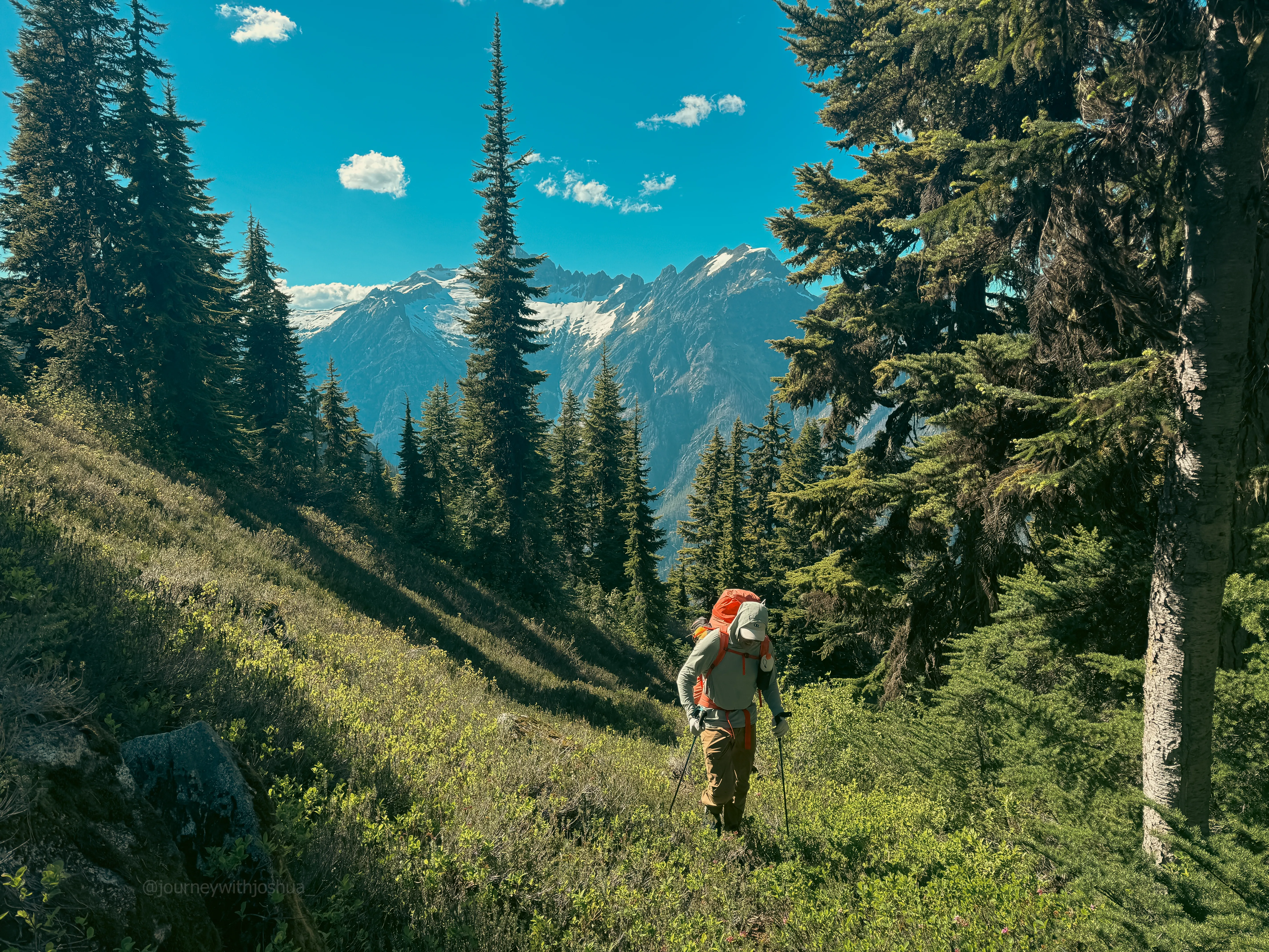 The steep slog continuing toward high camp with Snowfield Peak in the distance