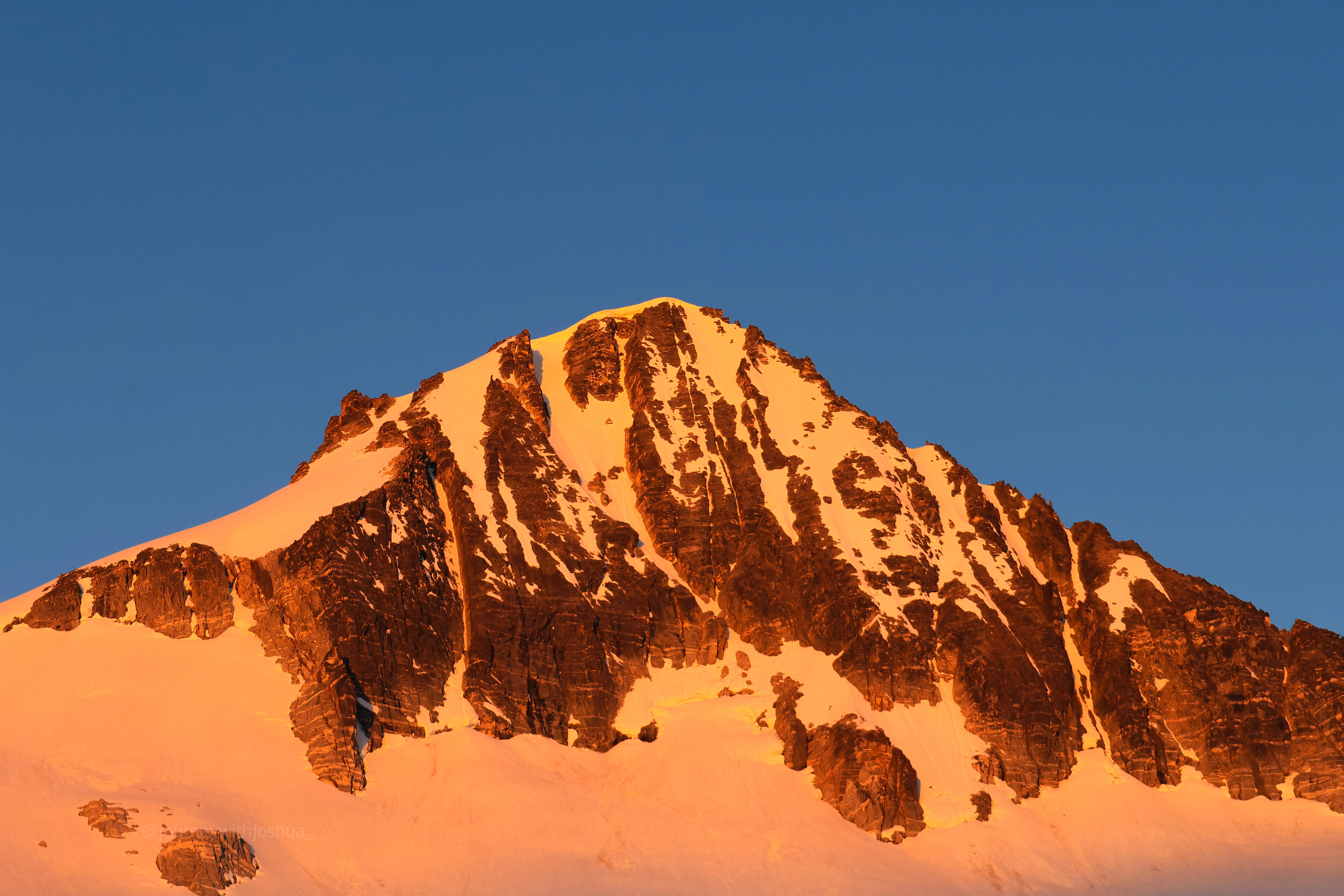 Alpenglow on the peaks at sunrise on summit morning