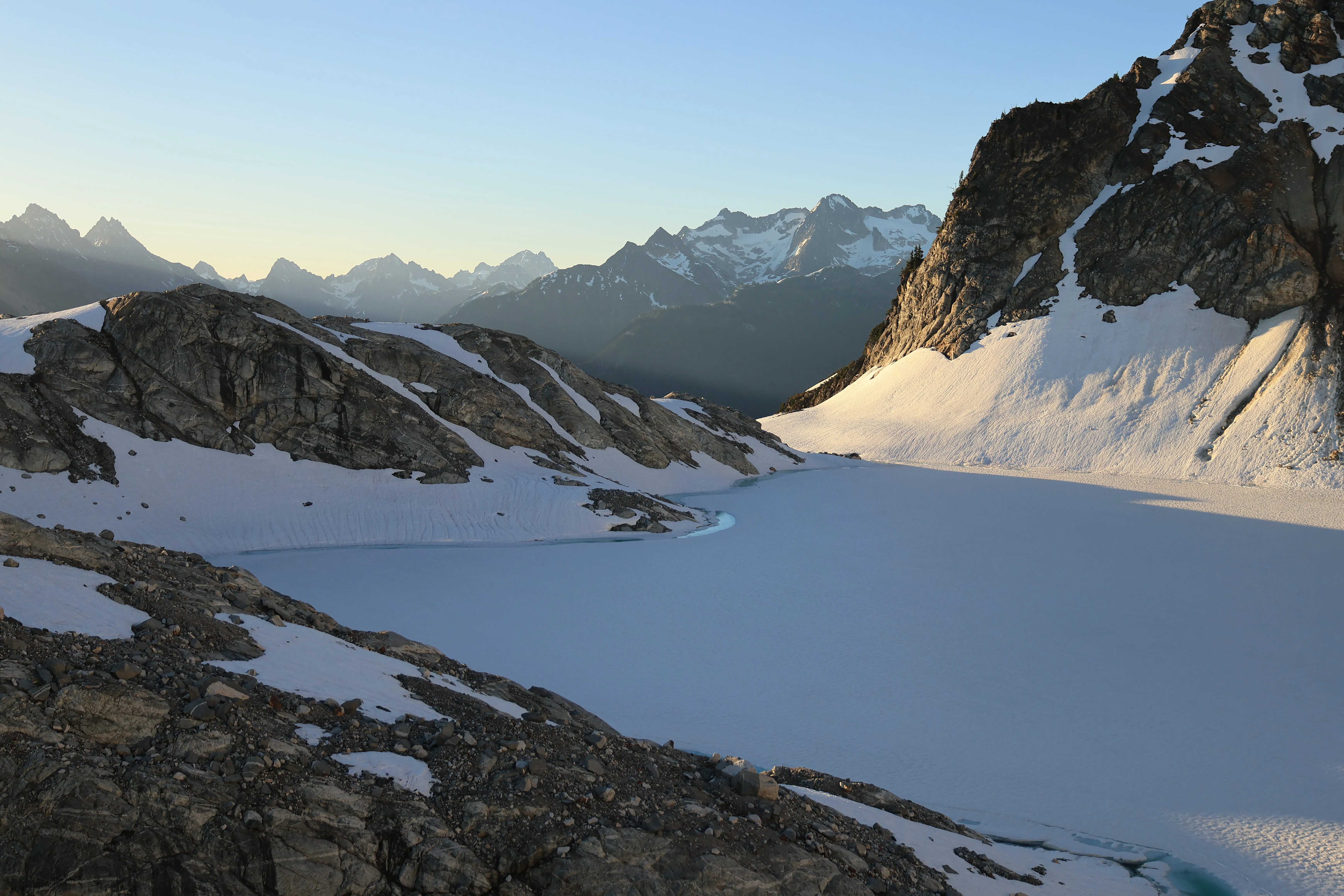 Sunrise over high camp with Borealis Lake still in shadow below