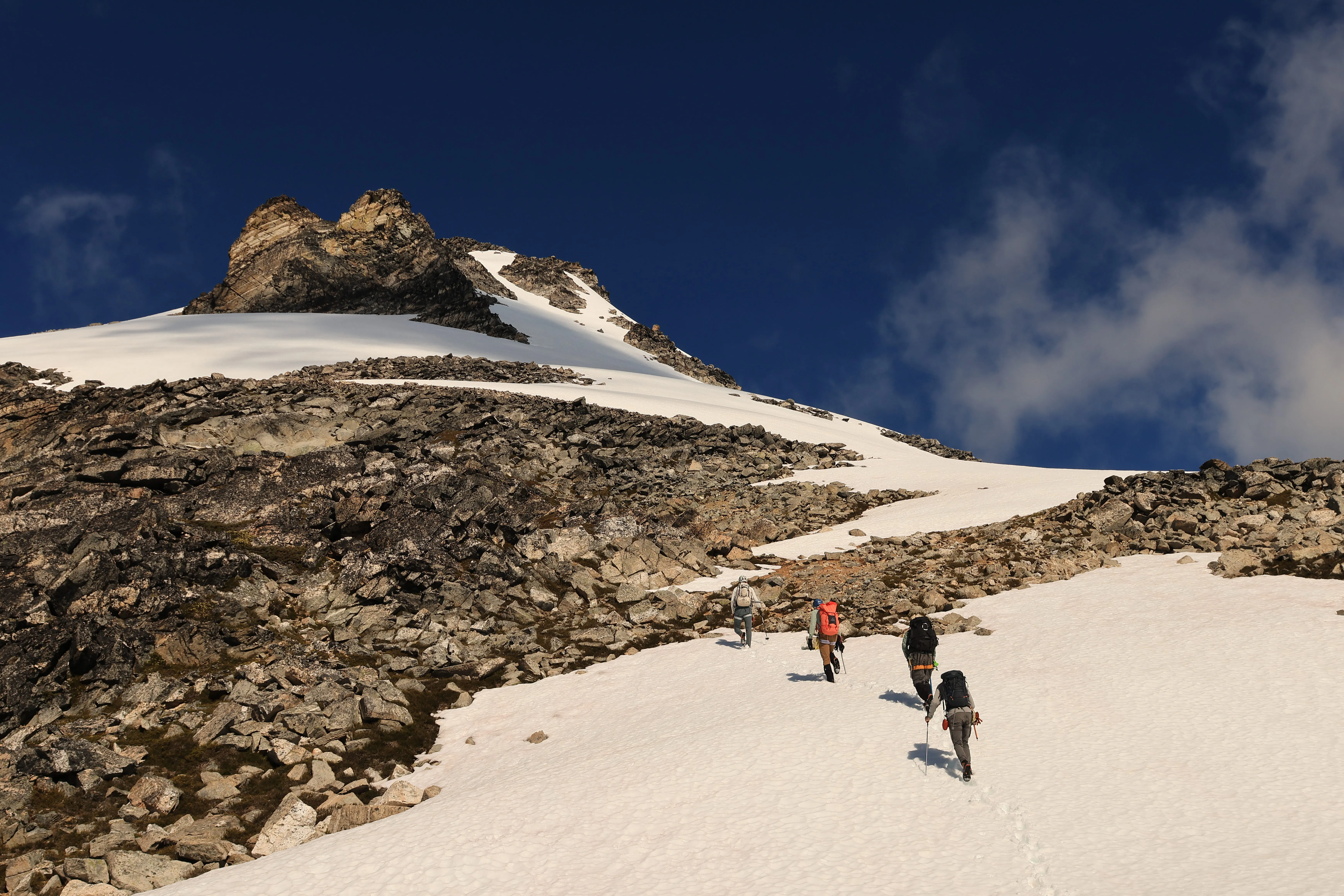 The team approaching the final steep snow below the summit