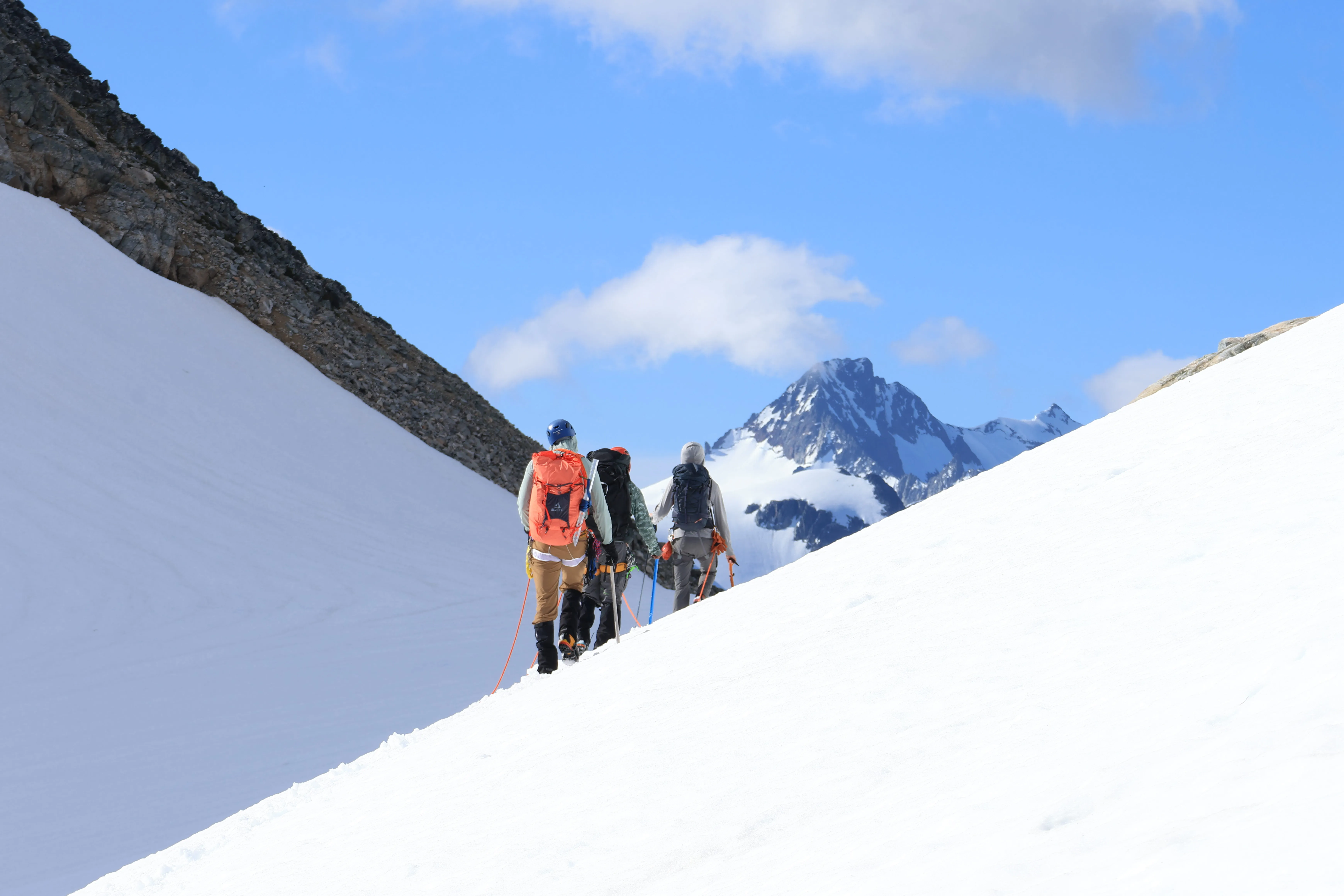 The team entering Lucky Pass with Boston and Sahale peeking around the corner