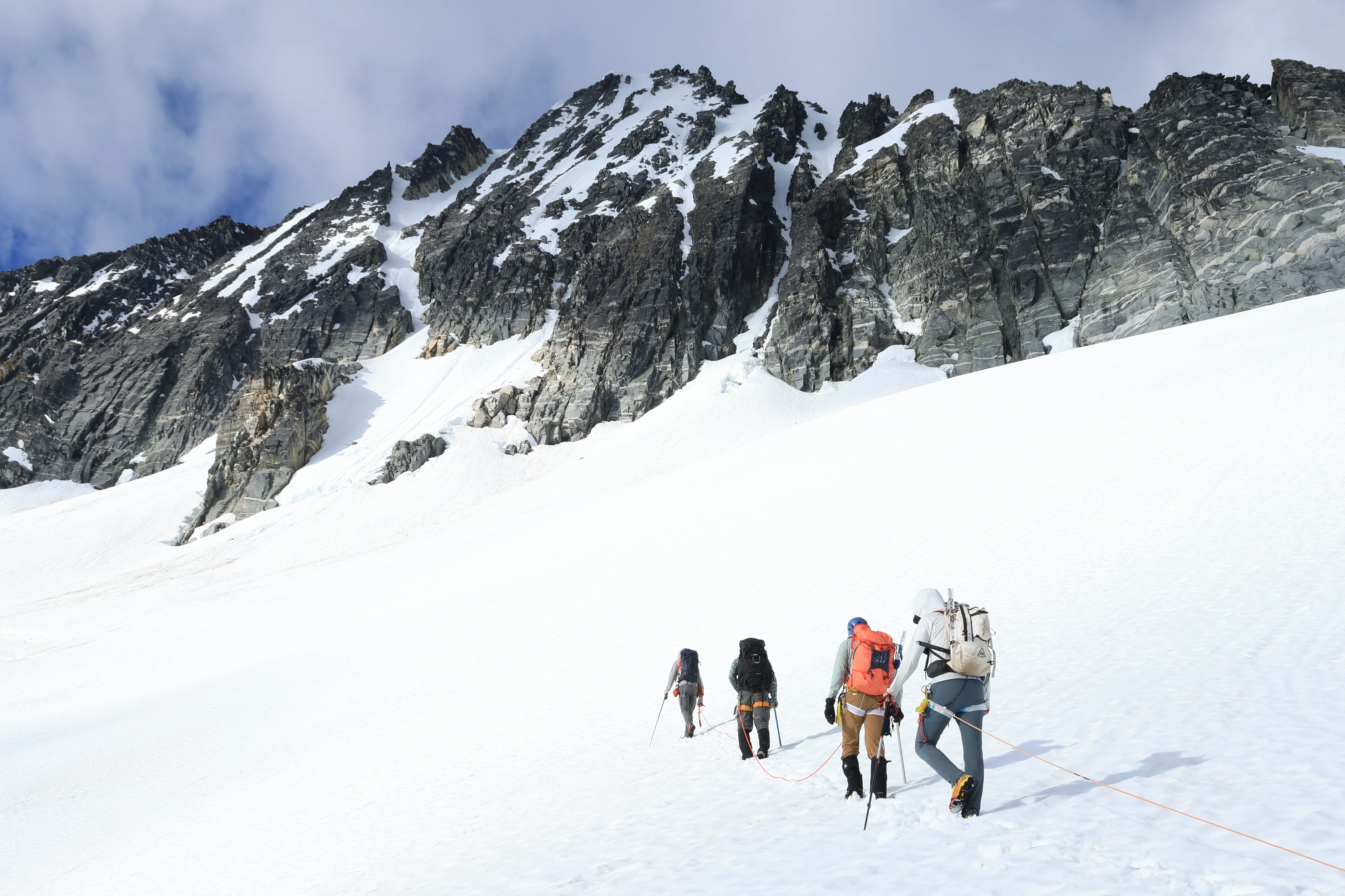 The roped-up team marching across the Borealis Glacier toward Lucky Pass