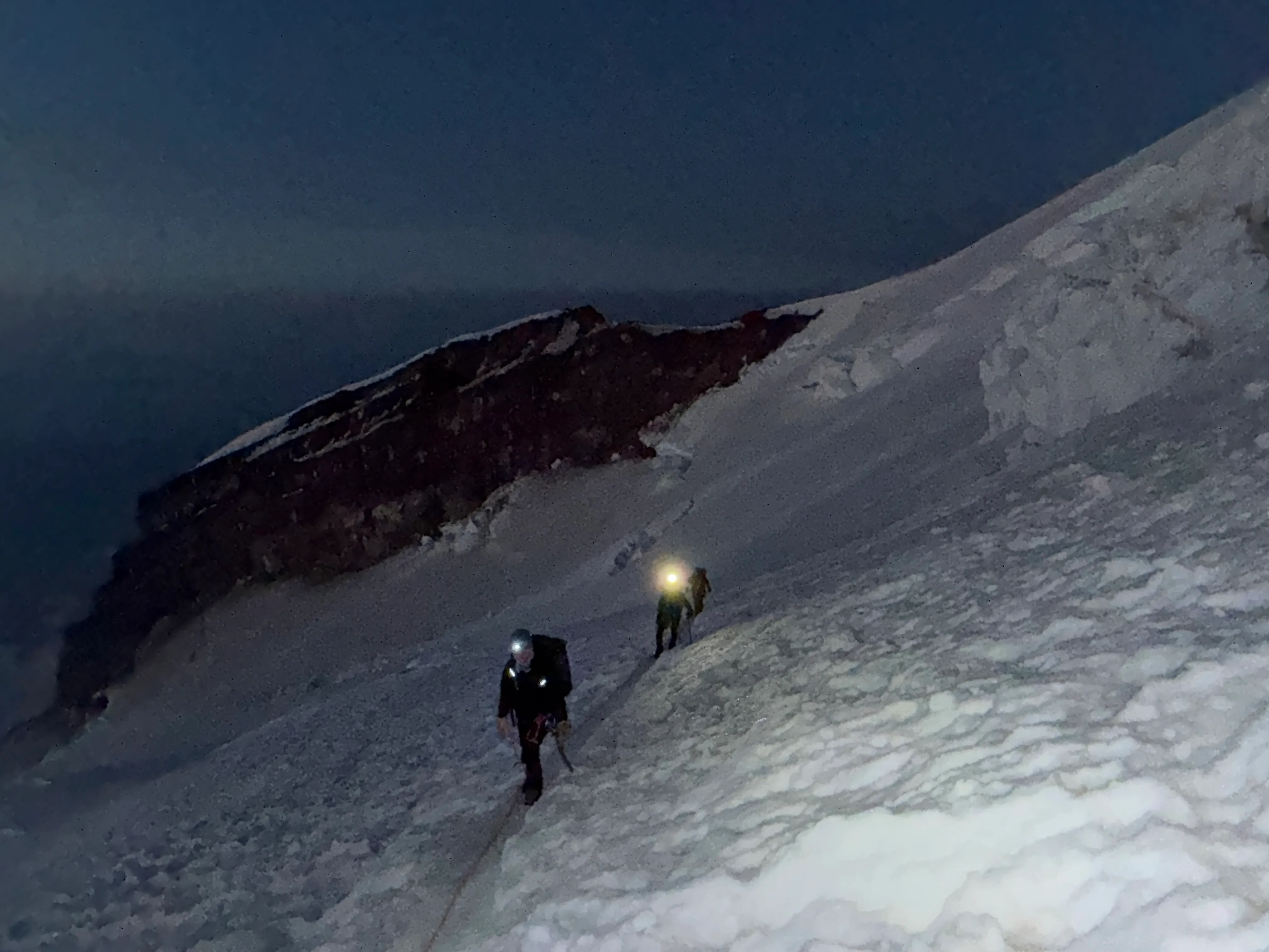 Headlamps on the dark glacier at the start of the summit push
