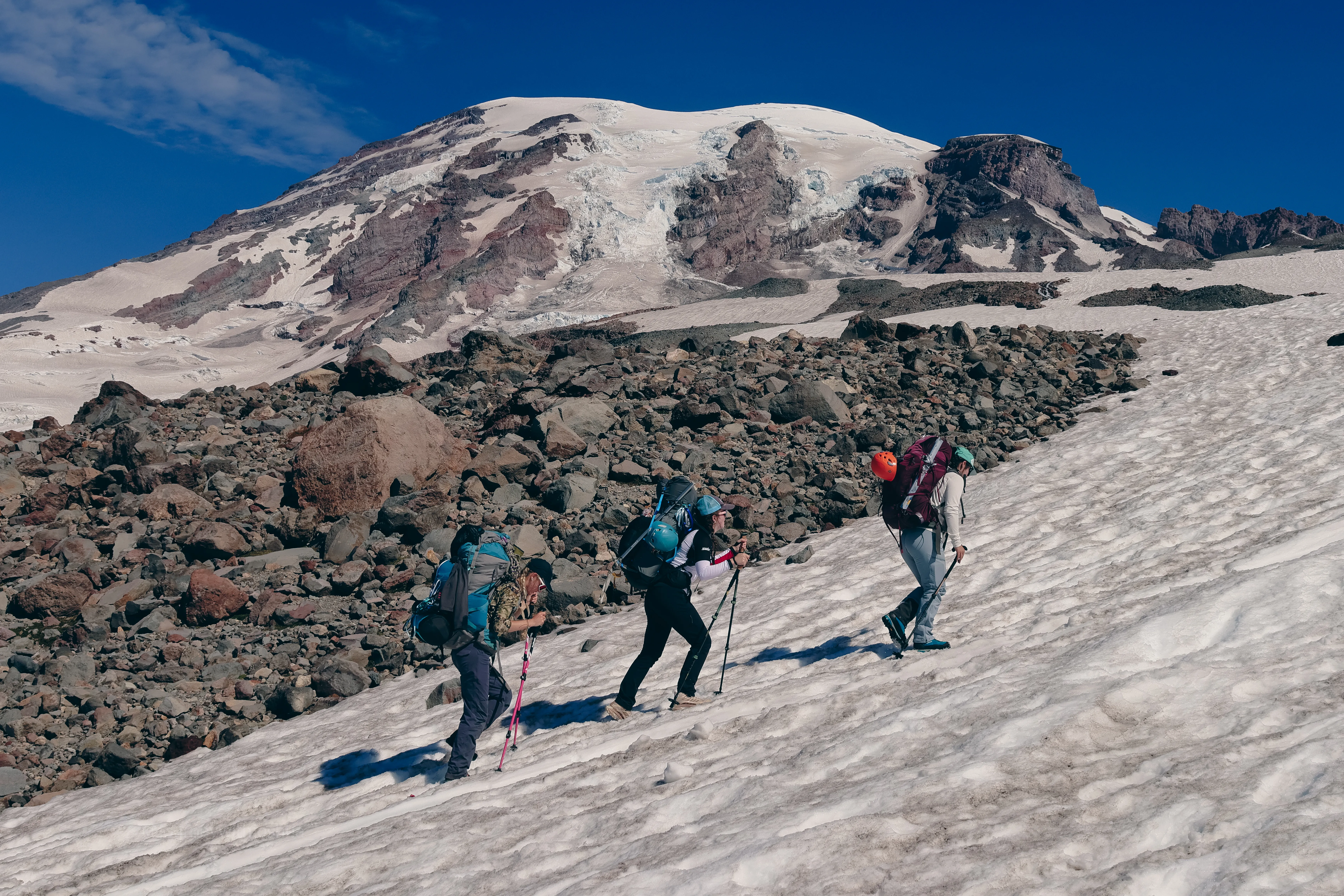 The team moving up the trail with heavy packs