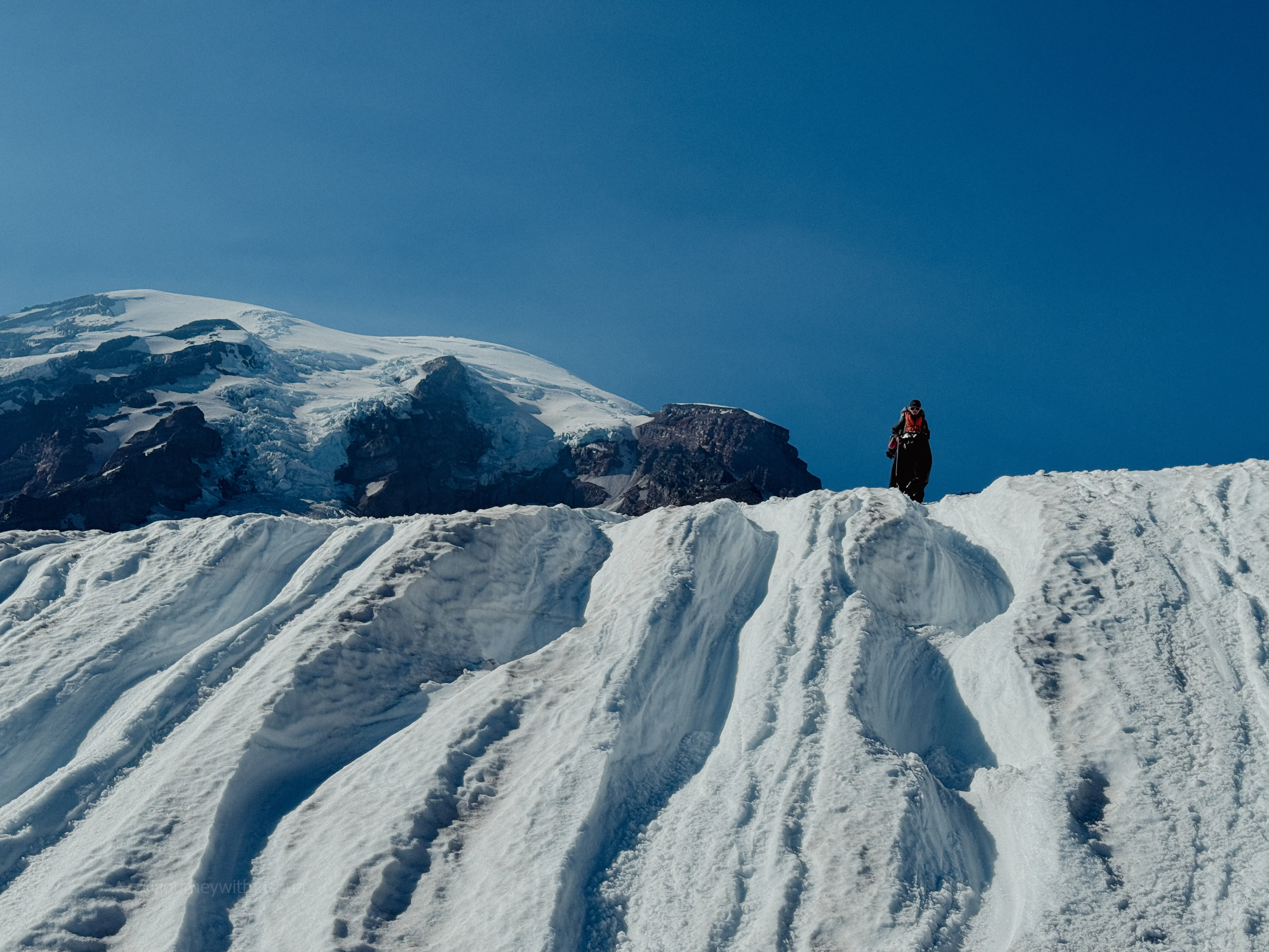 Julia carrying the rope on the last glissade of the descent