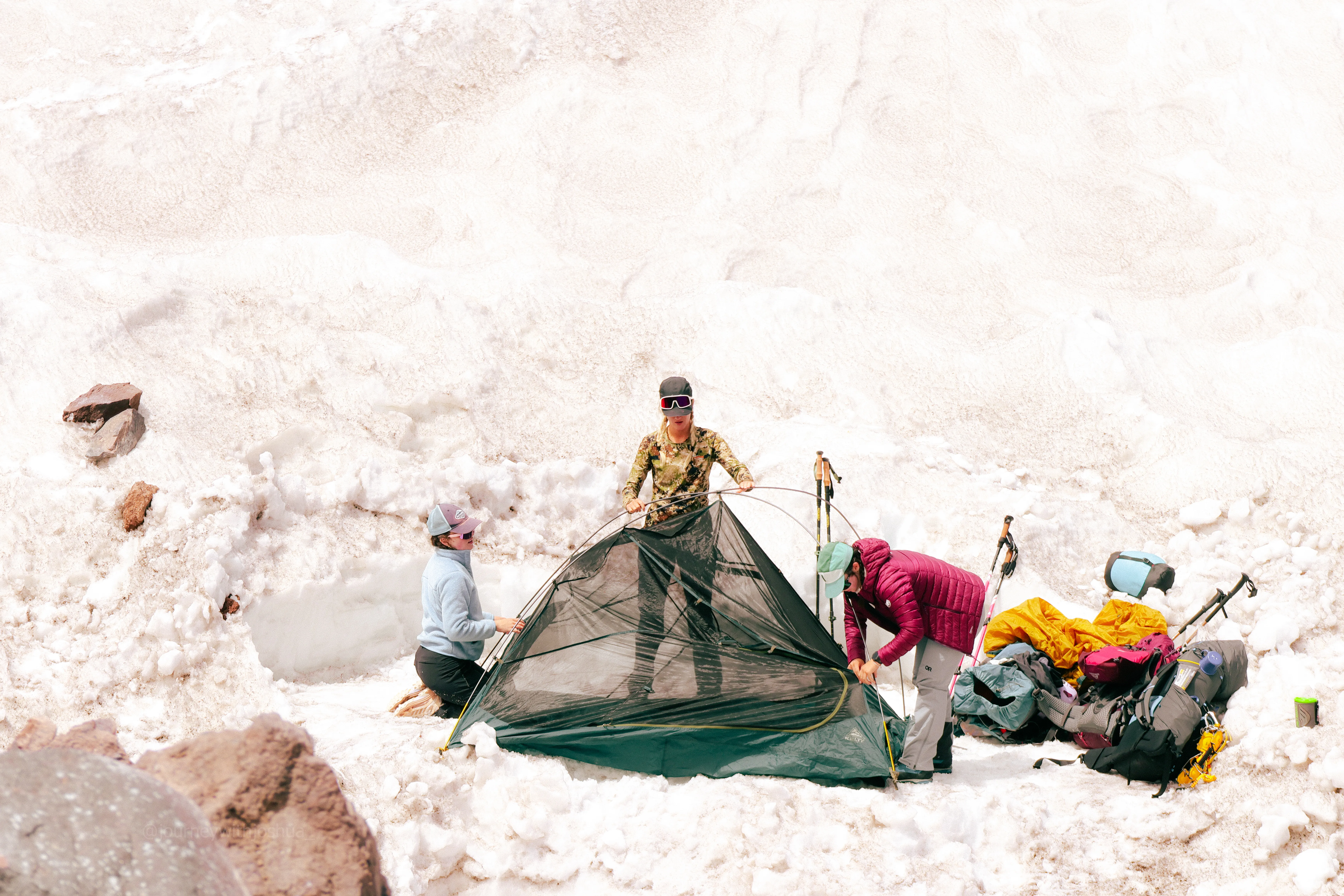 The team assembling their tent at Camp Muir