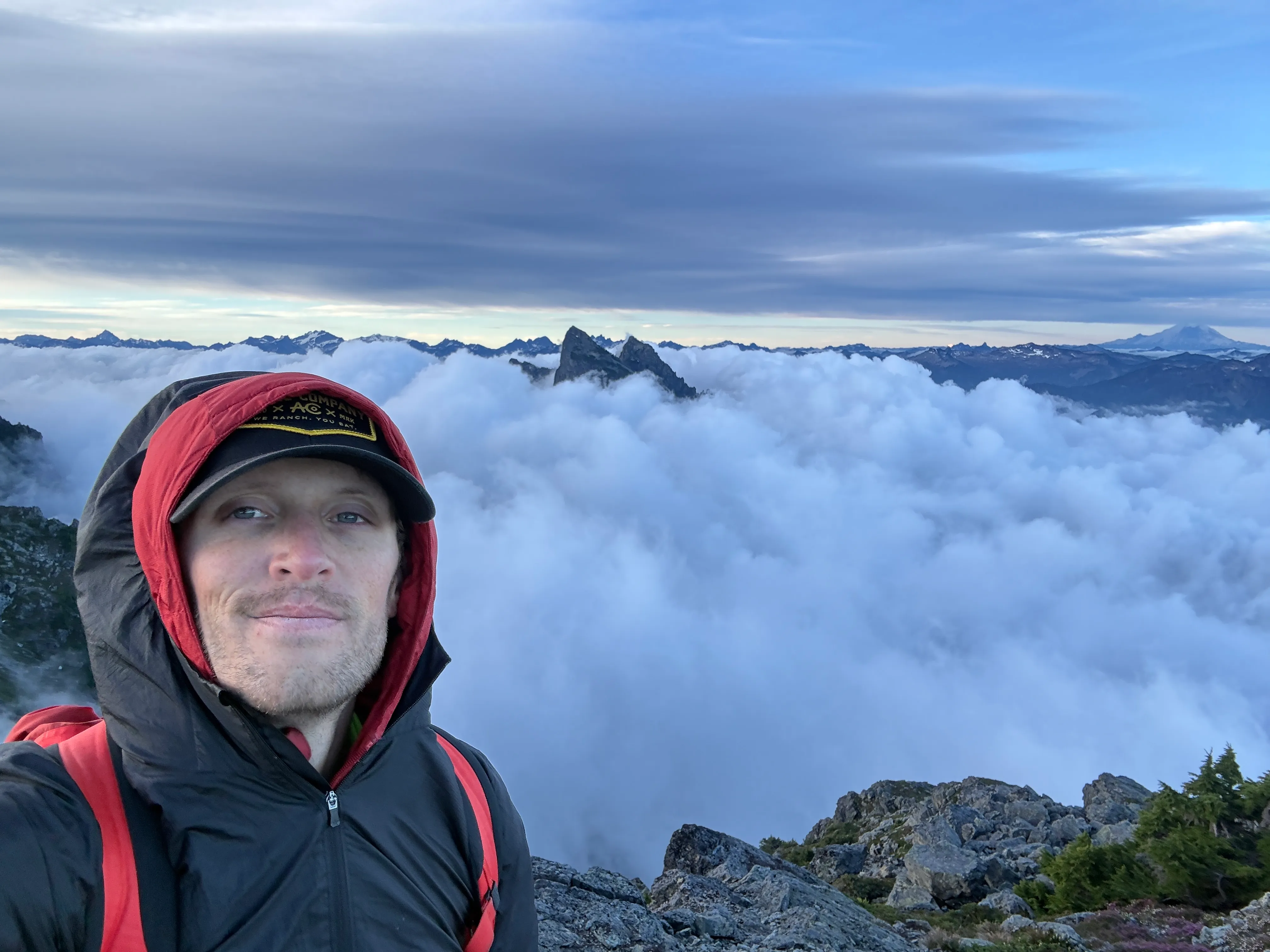 Summit selfie on Tailgunner with Baring Mountain in the clouds behind