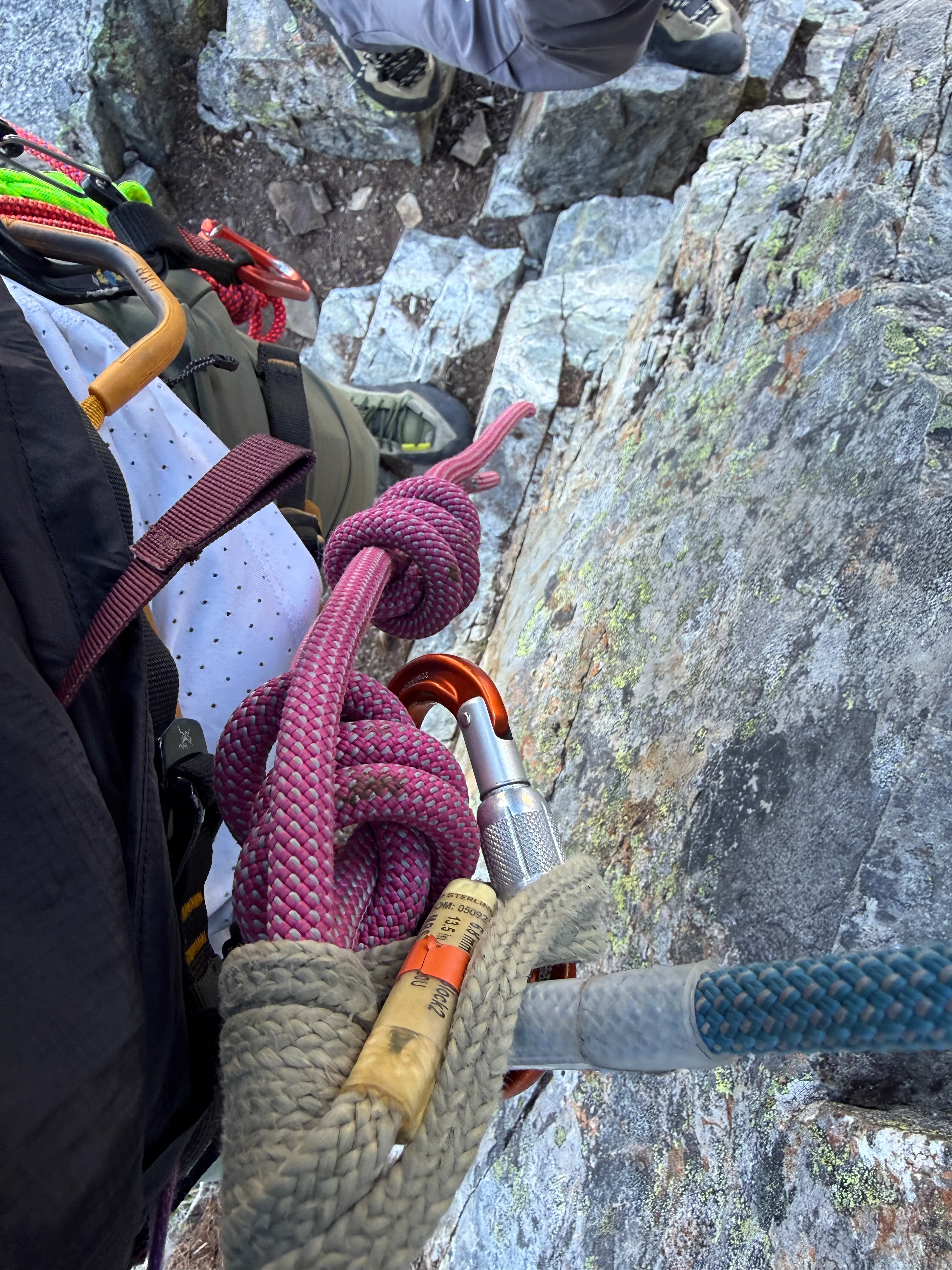 The end of the long rappel, at the knots with a third hand backup