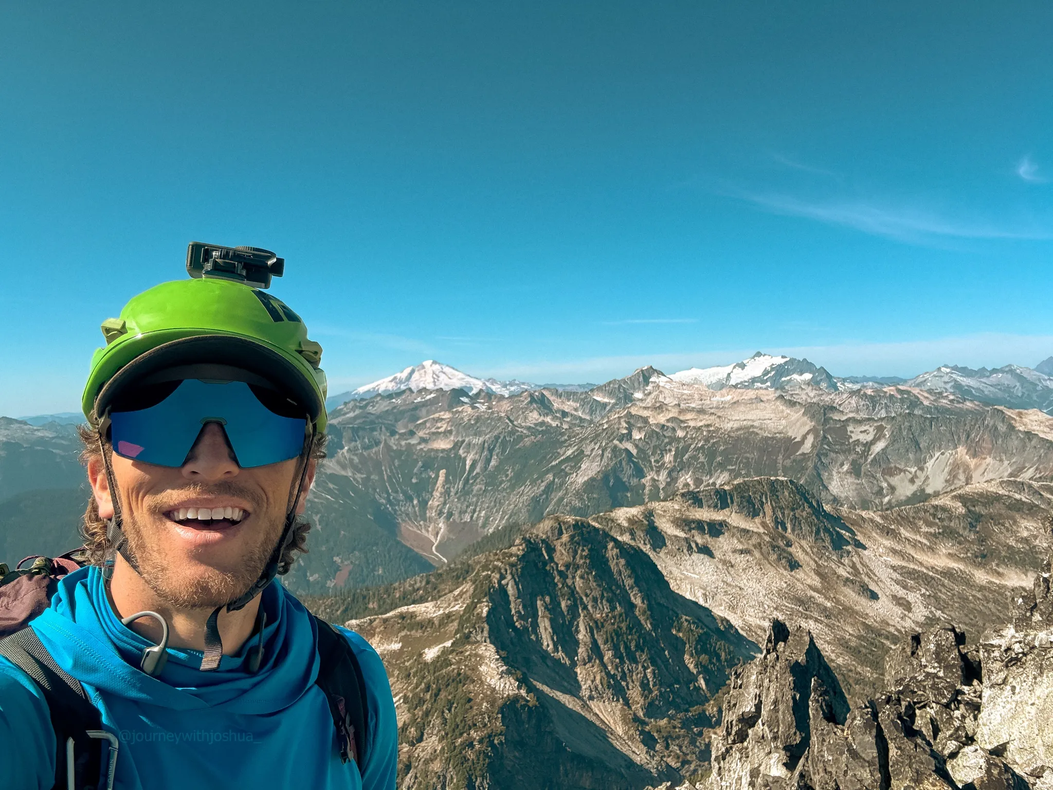 Summit bliss on Mount Triumph with Mount Baker, Mount Blum, and Mount Shuksan directly behind